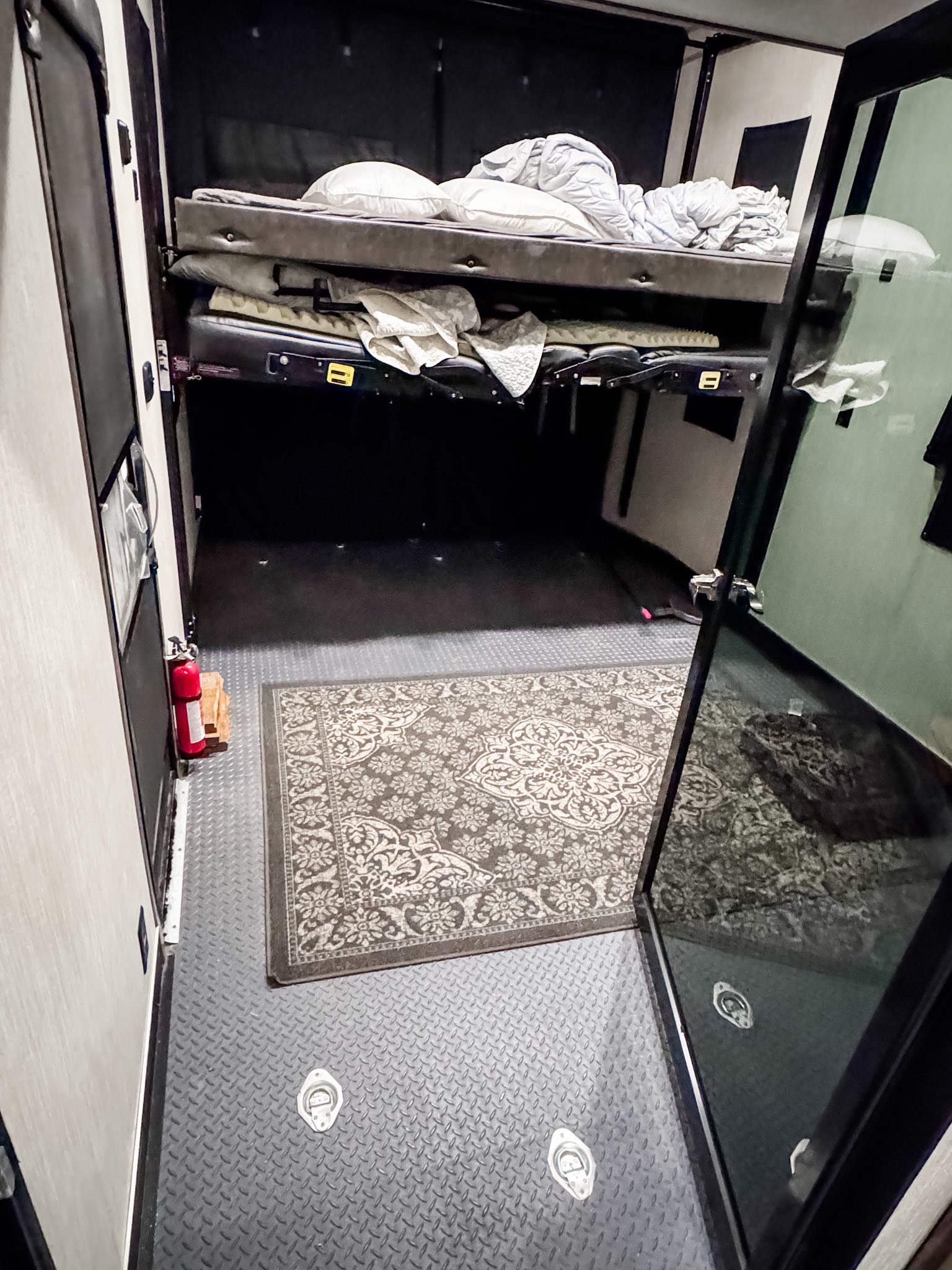 RV rental interior with bunk beds, diamond plate floor, area rug, fire extinguisher & tie-downs.. Forest River Cherokee Wolf Pack 2020