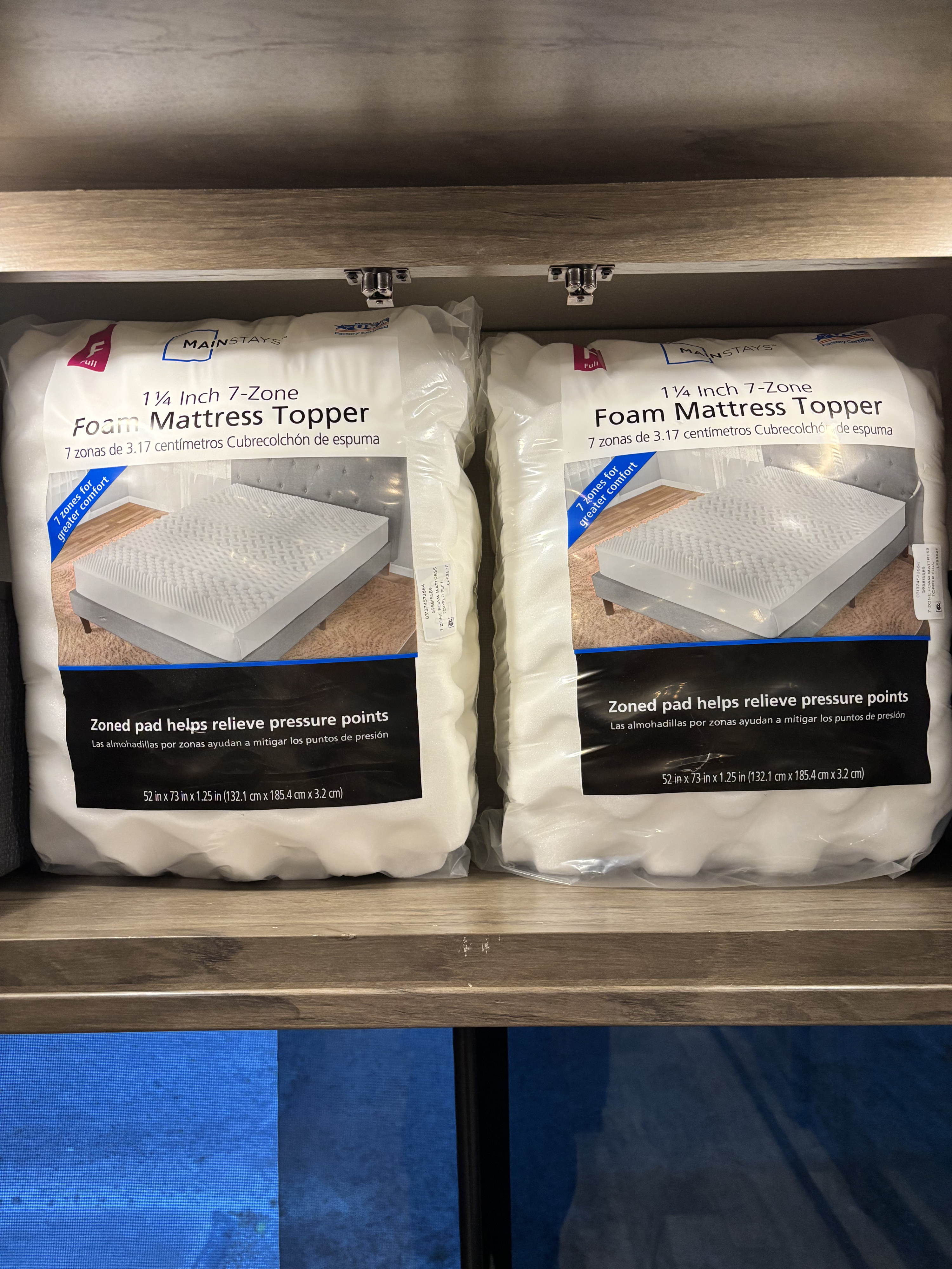 Two full-size Mainstays foam mattress toppers, enhancing comfort and pressure relief with 7 zones, stored in an RV rental.. Forest River Sanibel 2021