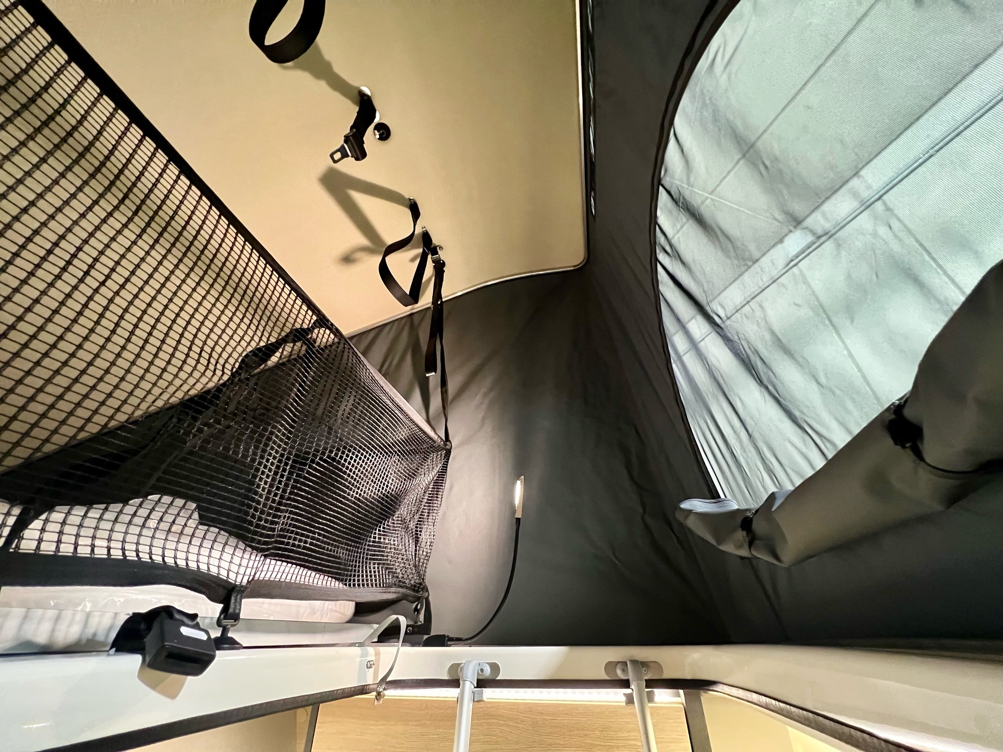 RV rental pop-top interior: Mesh storage net, illuminated flexible lamp, and ceiling straps for comfortable camping.. DREAMER D43 2026