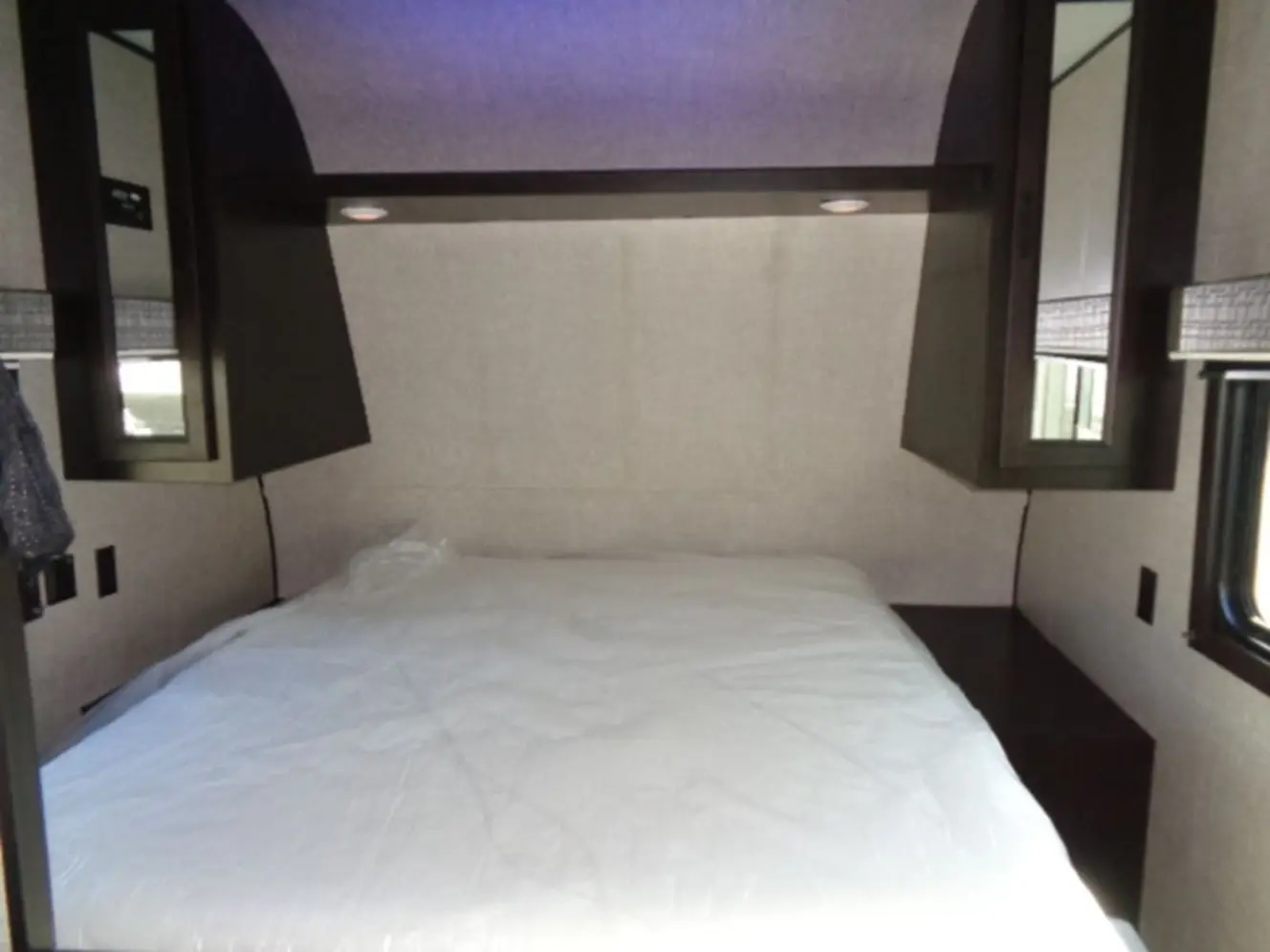 RV rental bedroom: a compact, clean sleeping area with a bed, overhead storage, and side cabinets for comfortable travel.. Jayco Jay Flight 2022