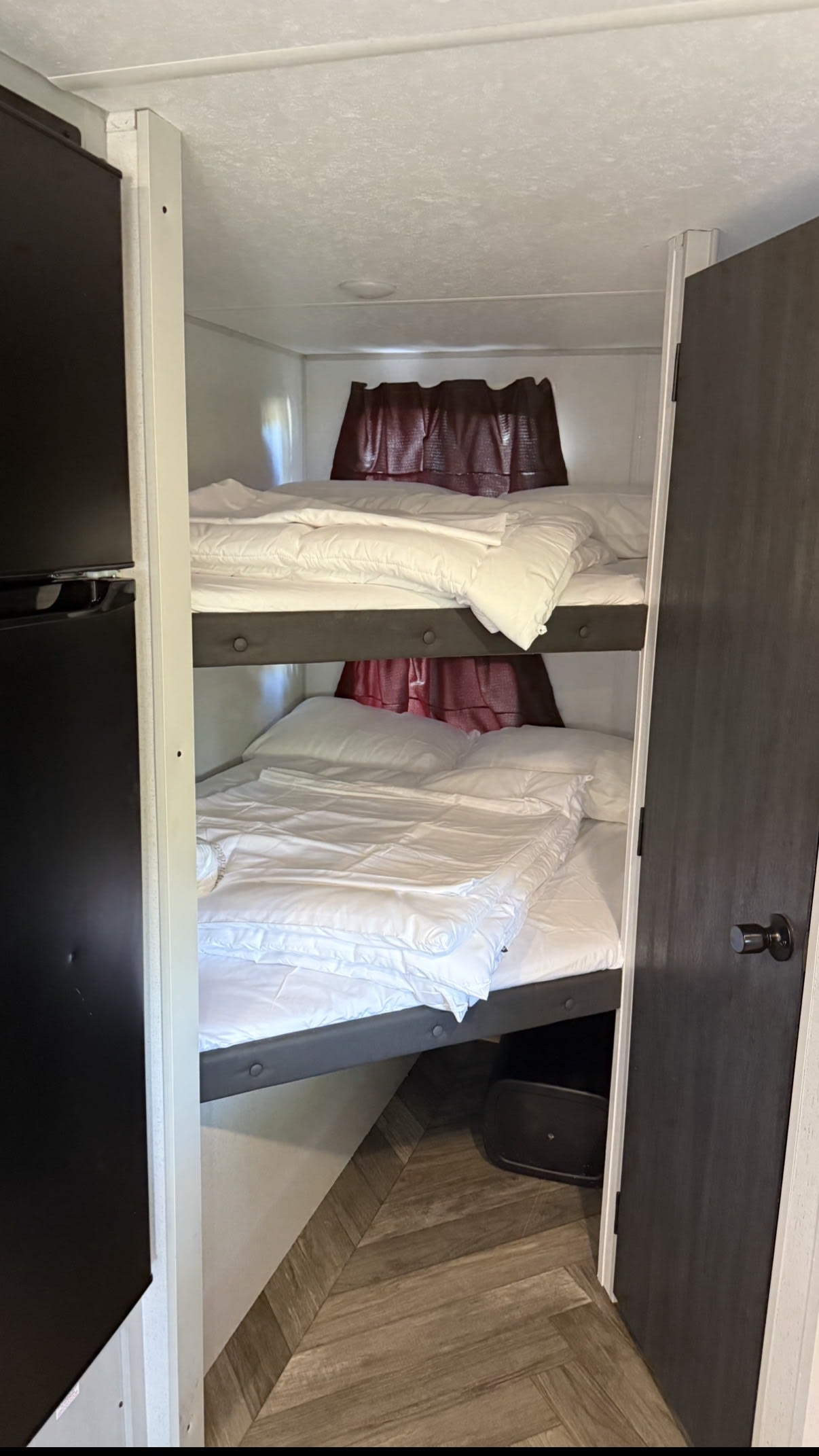 Cozy bunk beds with fresh white linens inside an RV rental, offering comfortable sleeping arrangements for travelers.. Forest River Salem FSX 2022