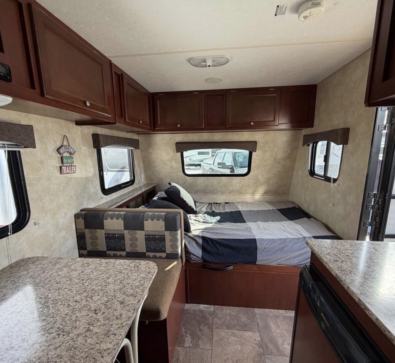 Cozy rv rental interior with a comfortable bed, dinette, and storage, ready for your next travel adventure.. Clipper Clipper Trailer 2014