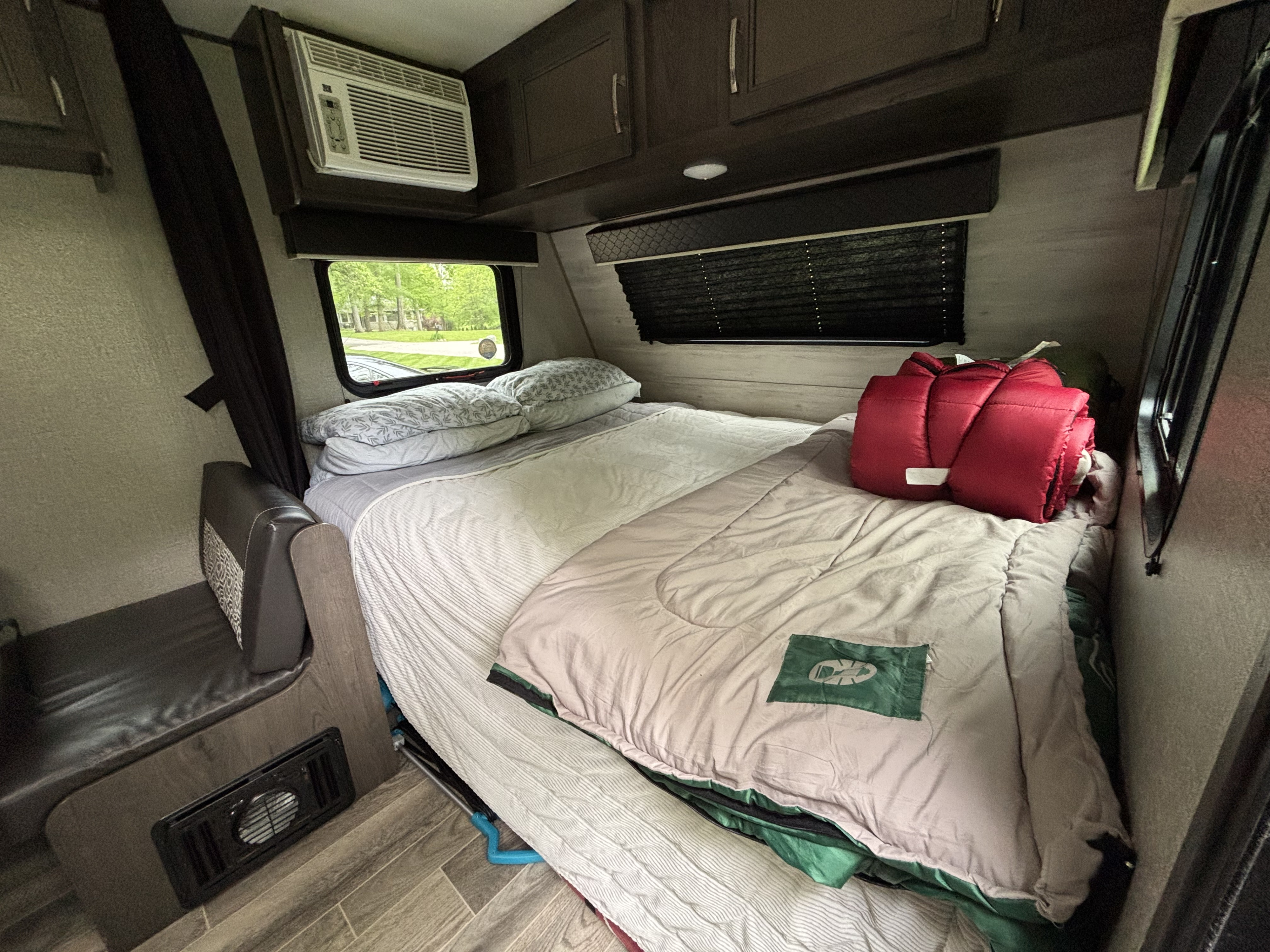 Inside an RV rental: a compact bedroom with AC, storage, and a comfy bed. Ready for your trip!. Jayco Jay Flight SLX 2021