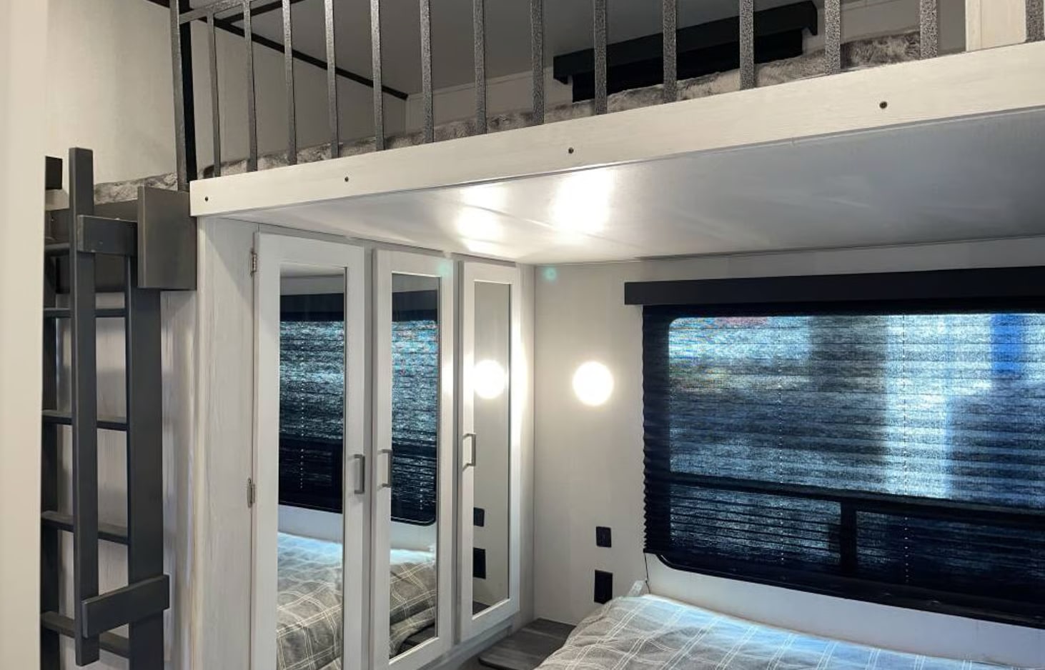 RV rental: A cozy bedroom features a bed, mirrored closets, a window, and a ladder leading to an overhead loft area.. Keystone RV Sprinter 2022