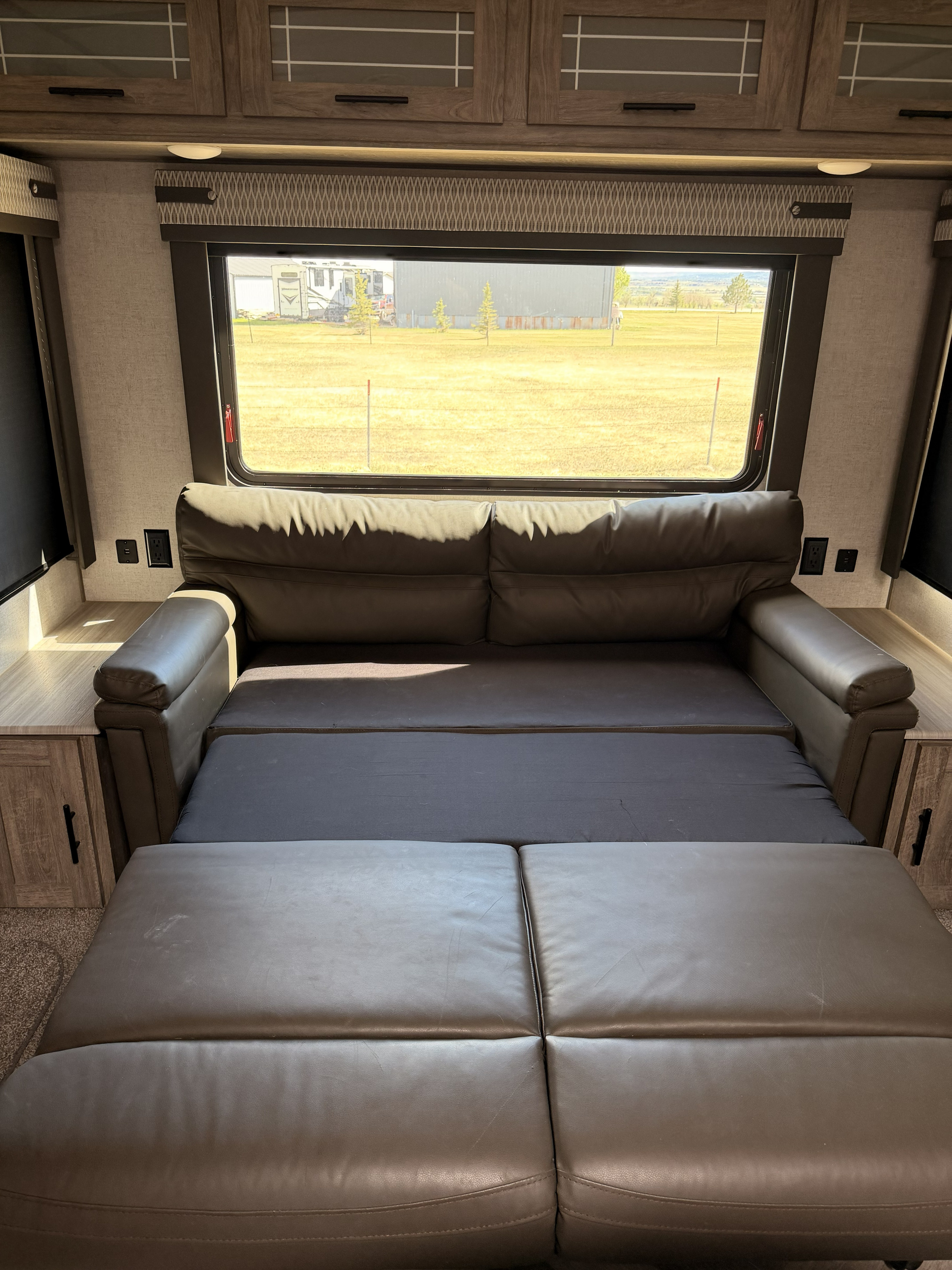 Transformative RV rental interior featuring a comfortable sofa that converts into a bed, ideal for a functional living space.. Forest River Salem Hemisphere 2020