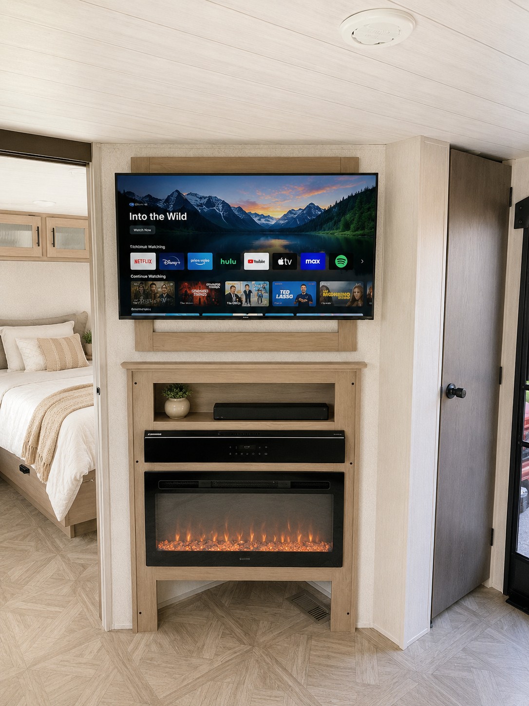 This RV rental's cozy living area boasts a TV with streaming, an electric fireplace, and a connected bedroom. Relax in comfort.. Forest River Salem 2024
