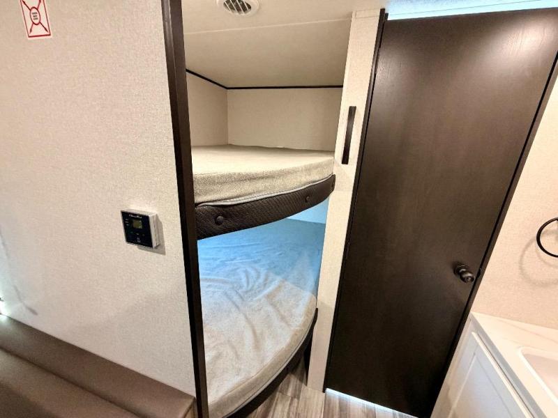 This RV rental features comfy bunk beds, a digital thermostat, and a privacy door for the bath/closet area.. Jayco Flight SLX 260BH 2026