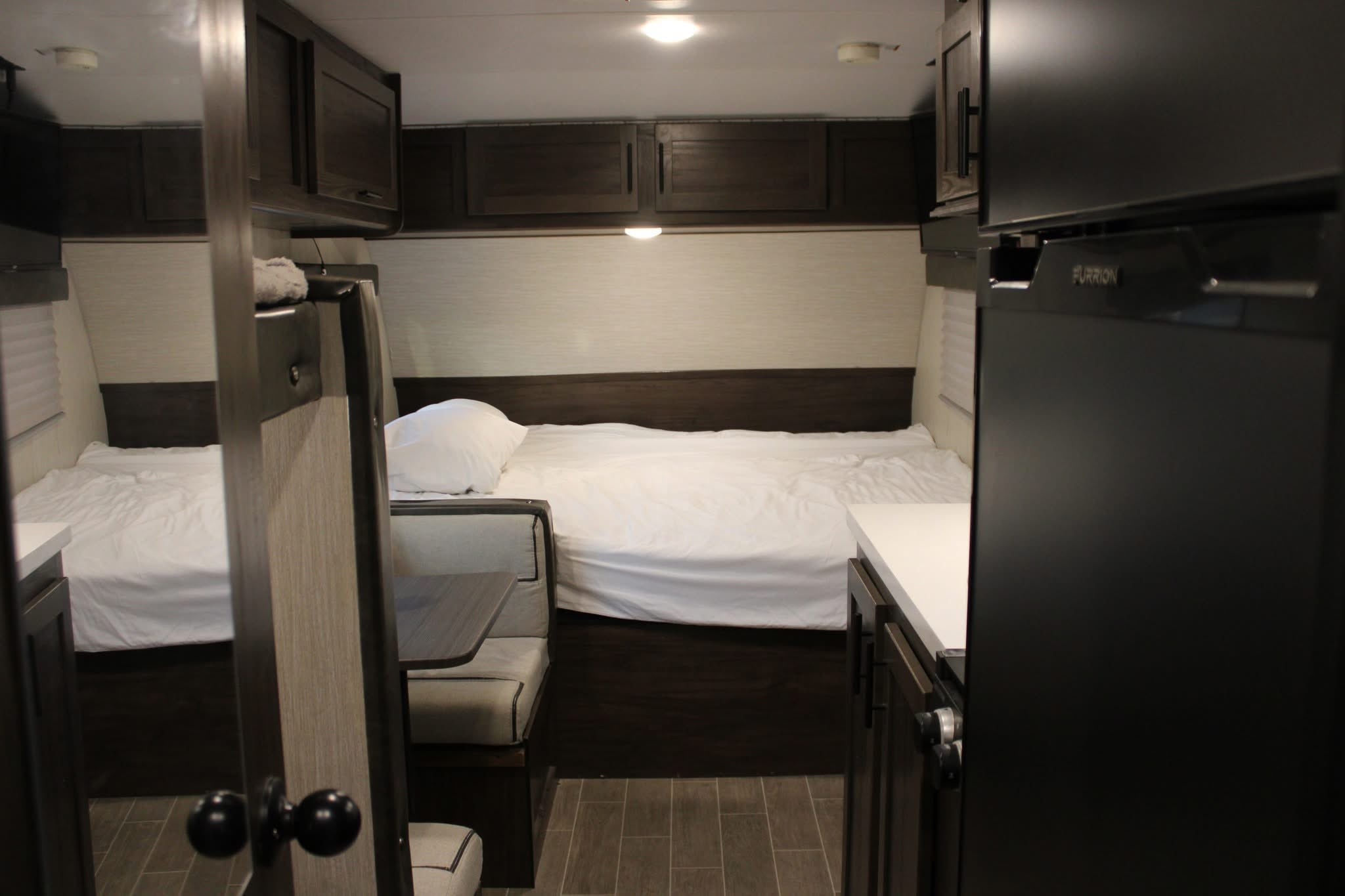 Explore this RV rental's modern interior featuring two sleeping areas, a cozy dinette, and a compact kitchen.. Forest River Cherokee Wolf Pup 2020