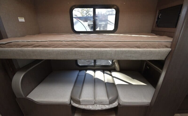 This **RV rental** features cozy bunk beds above a convertible dinette with windows and a TV. Ideal for family travel.. Thor Freedom Elite 2017