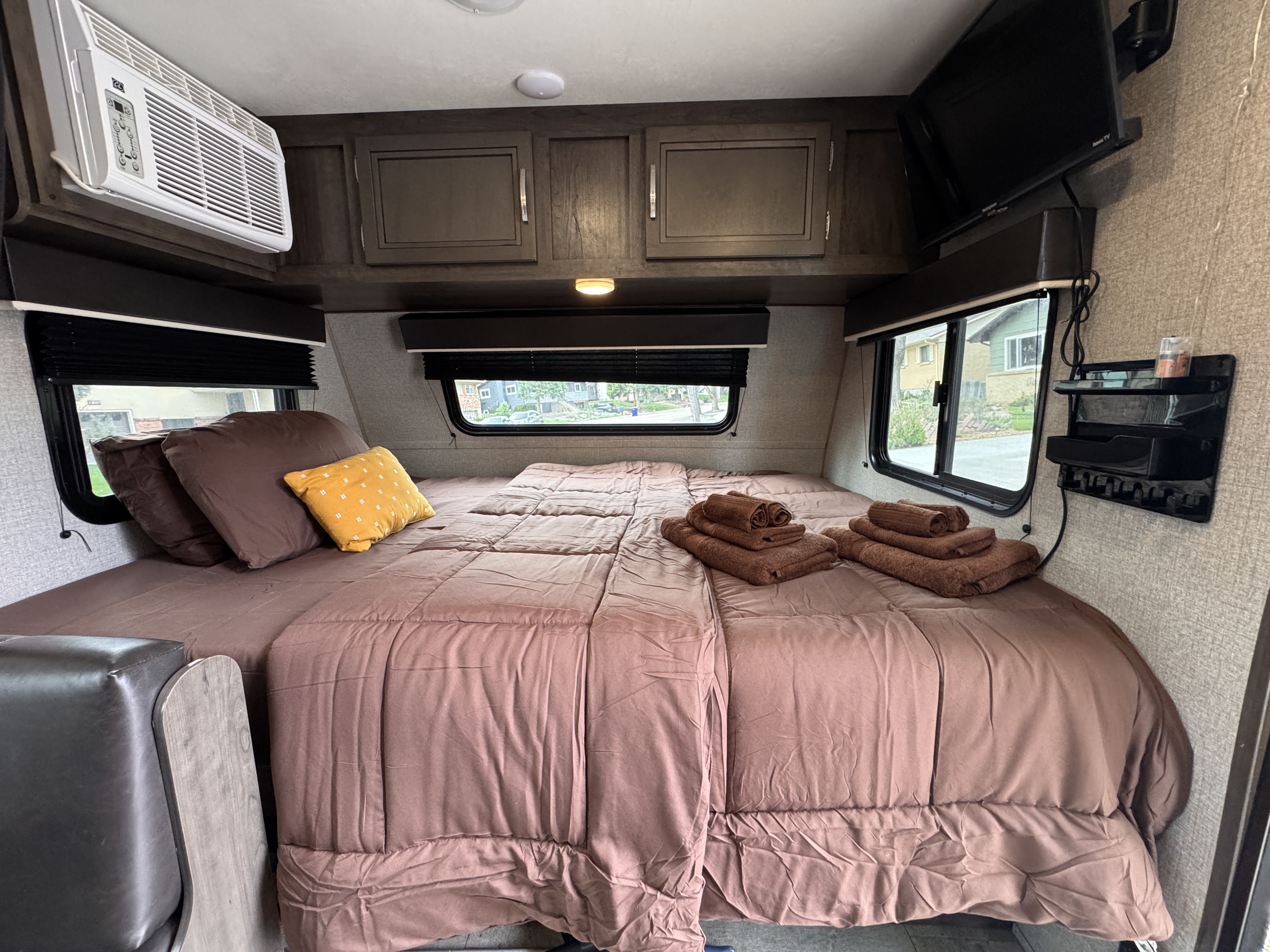 Cozy RV rental bedroom with a spacious bed, AC, TV, overhead cabinets, and windows for a relaxing stay.. Jayco Jay Flight SLX Baja Edition 2020