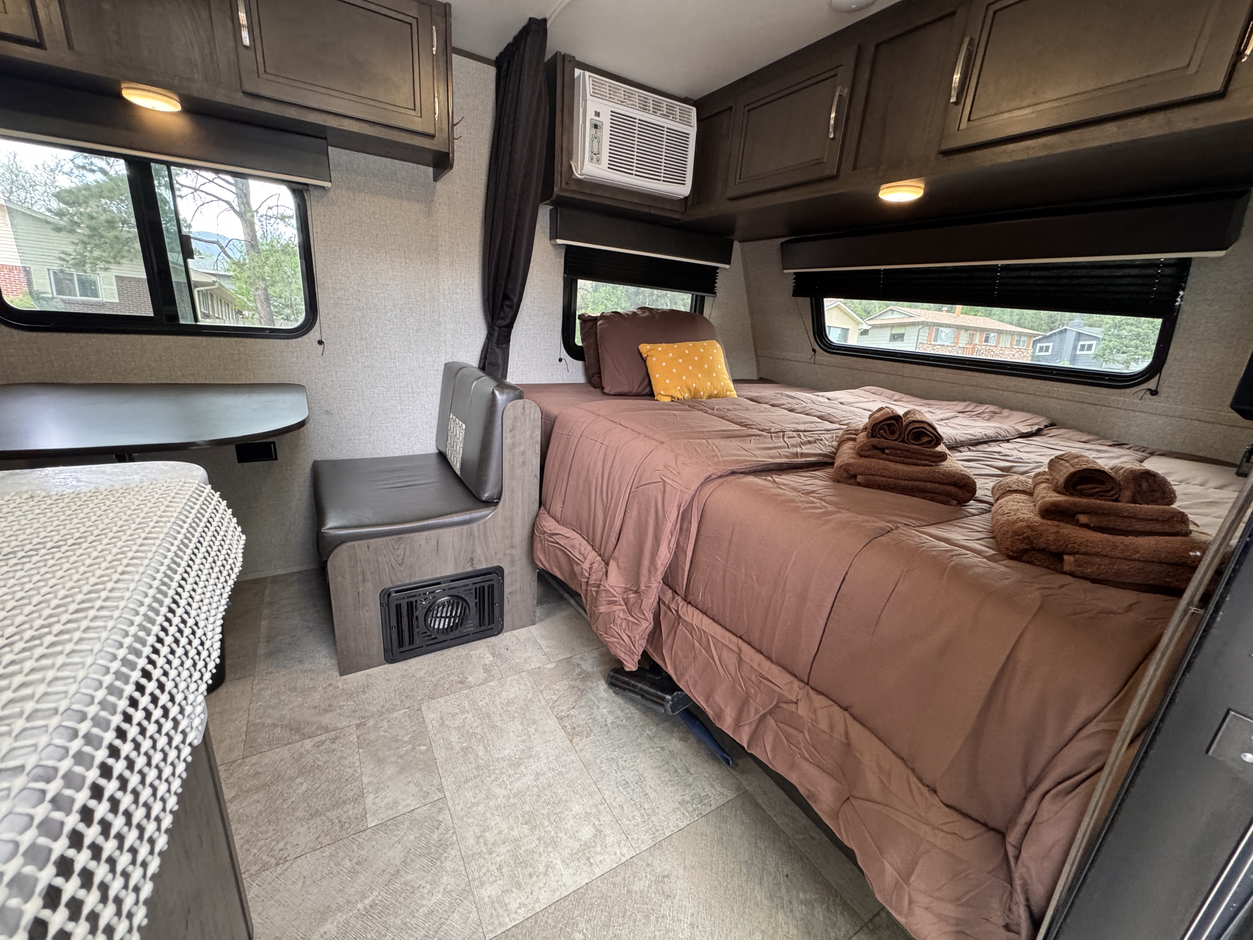 Inside a comfortable RV rental: Bedroom with brown bedding, dinette, and AC unit.. Jayco Jay Flight SLX Baja Edition 2020