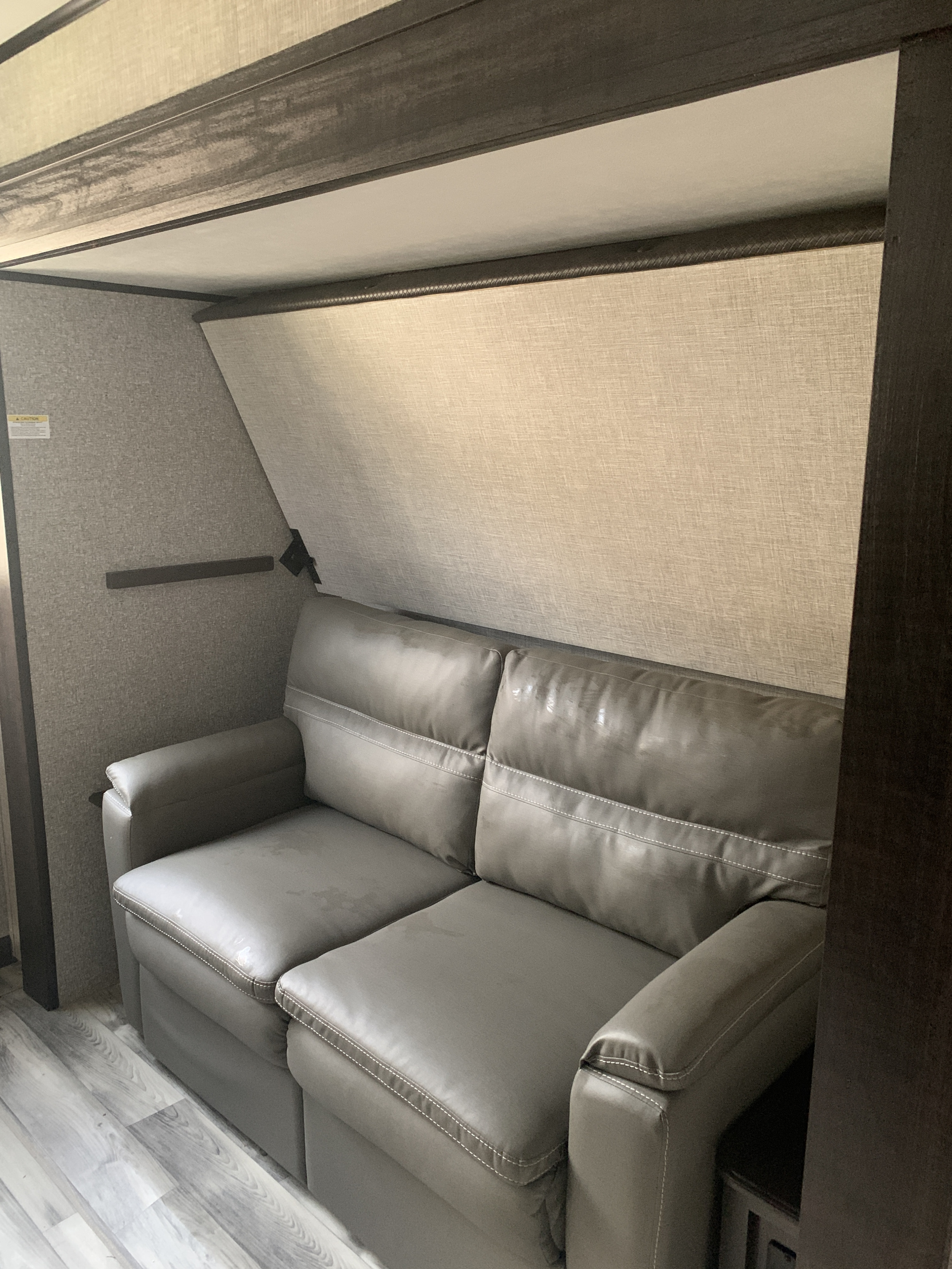 RV rental: Interior with a gray faux leather sofa and a partially lowered bunk bed above, within a compact living space.. Jayco Eagle HT 2022