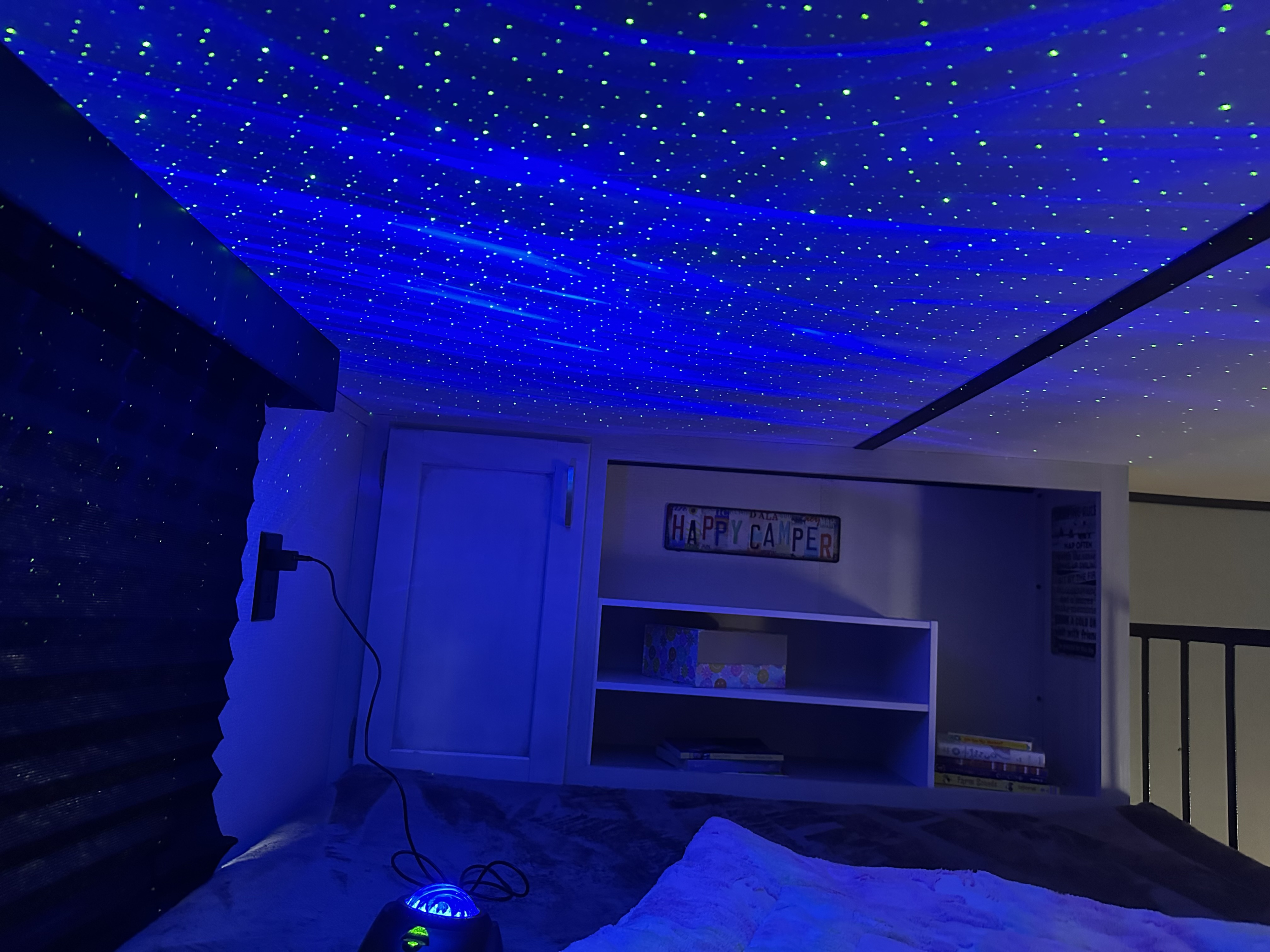 Experience a magical night in this RV rental! Features a cozy bunk bed, stunning starry ceiling, and a fun "Happy Camper" sign.. Keystone RV Sprinter 2022