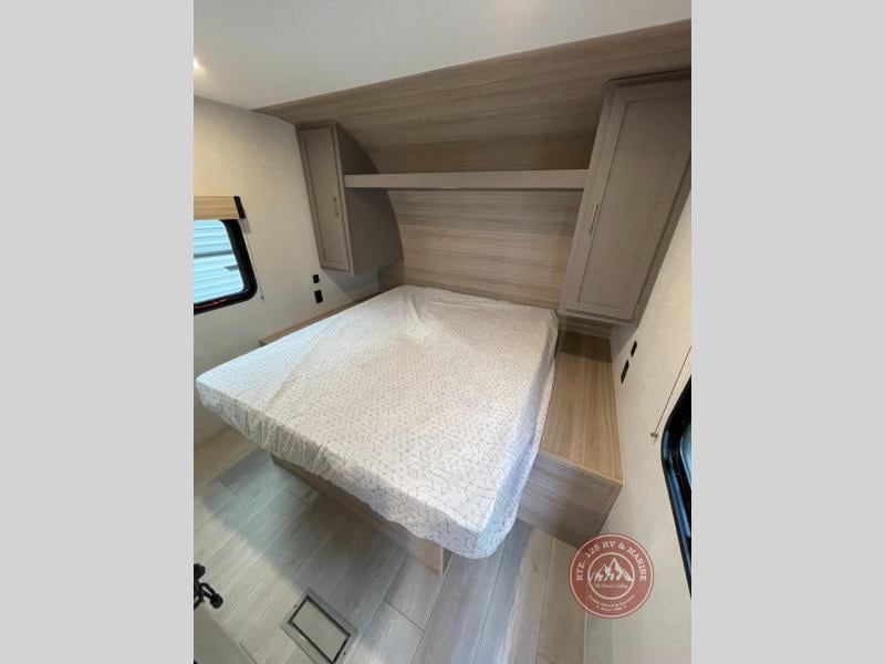 This RV rental bedroom features a comfy bed, overhead storage, and a window. Perfect for your next adventure.. KZ Sportsmen Select 2026