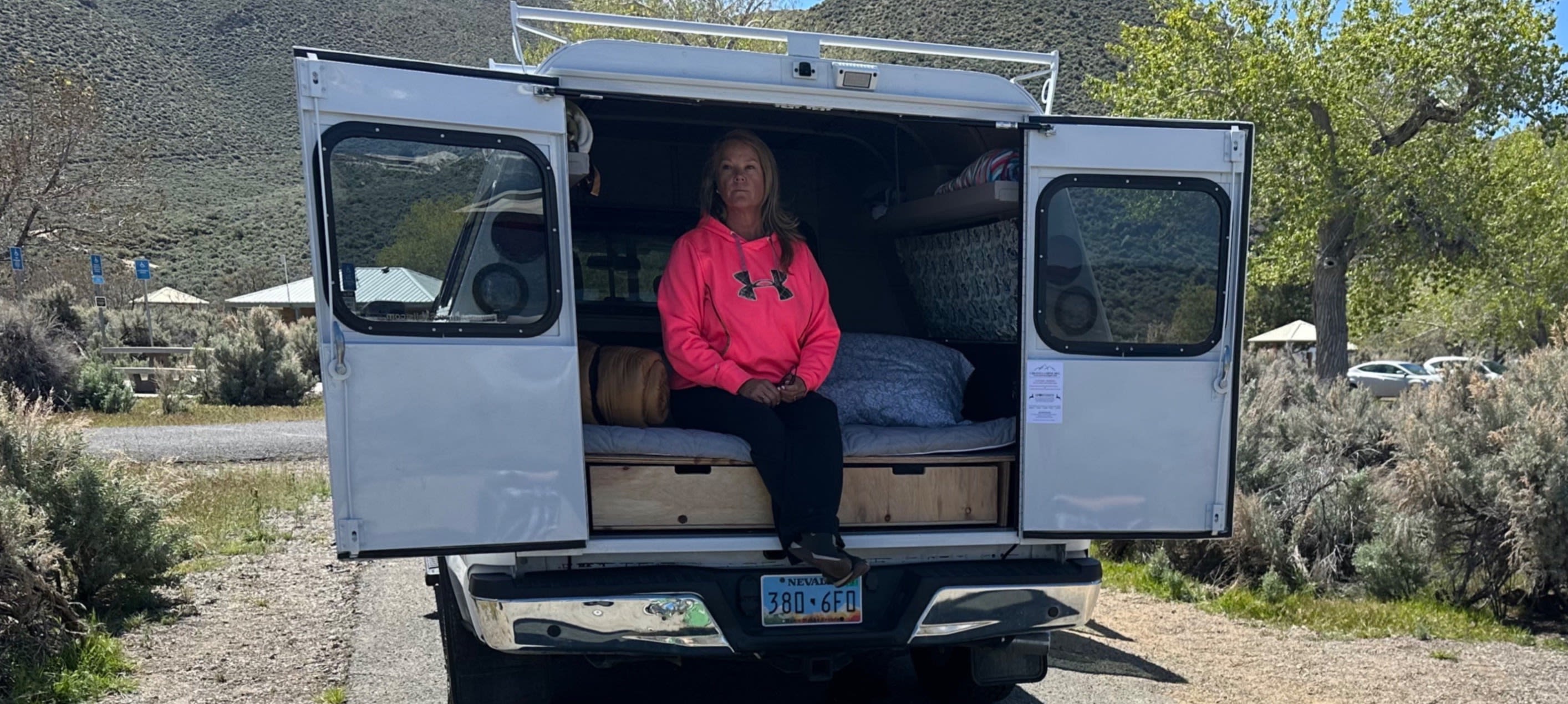 Enjoying an RV rental getaway: A woman & dog relaxing at their camper van campsite in sunny Nevada.. Ford Ford F150 2017