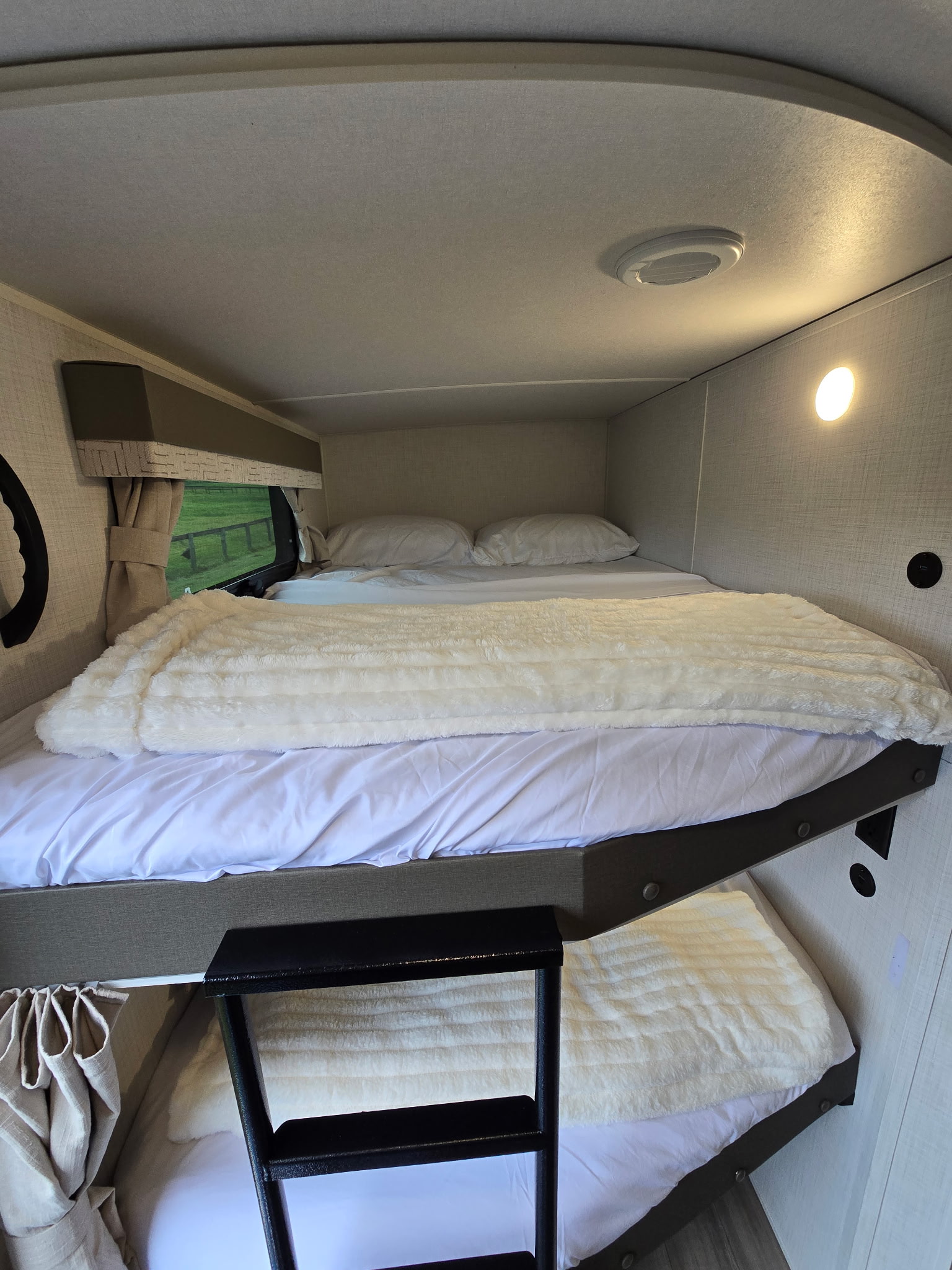 Bright rv rental interior featuring comfortable bunk beds with white sheets and fluffy blankets.. Forest River Flagstaff Super Lite 2024