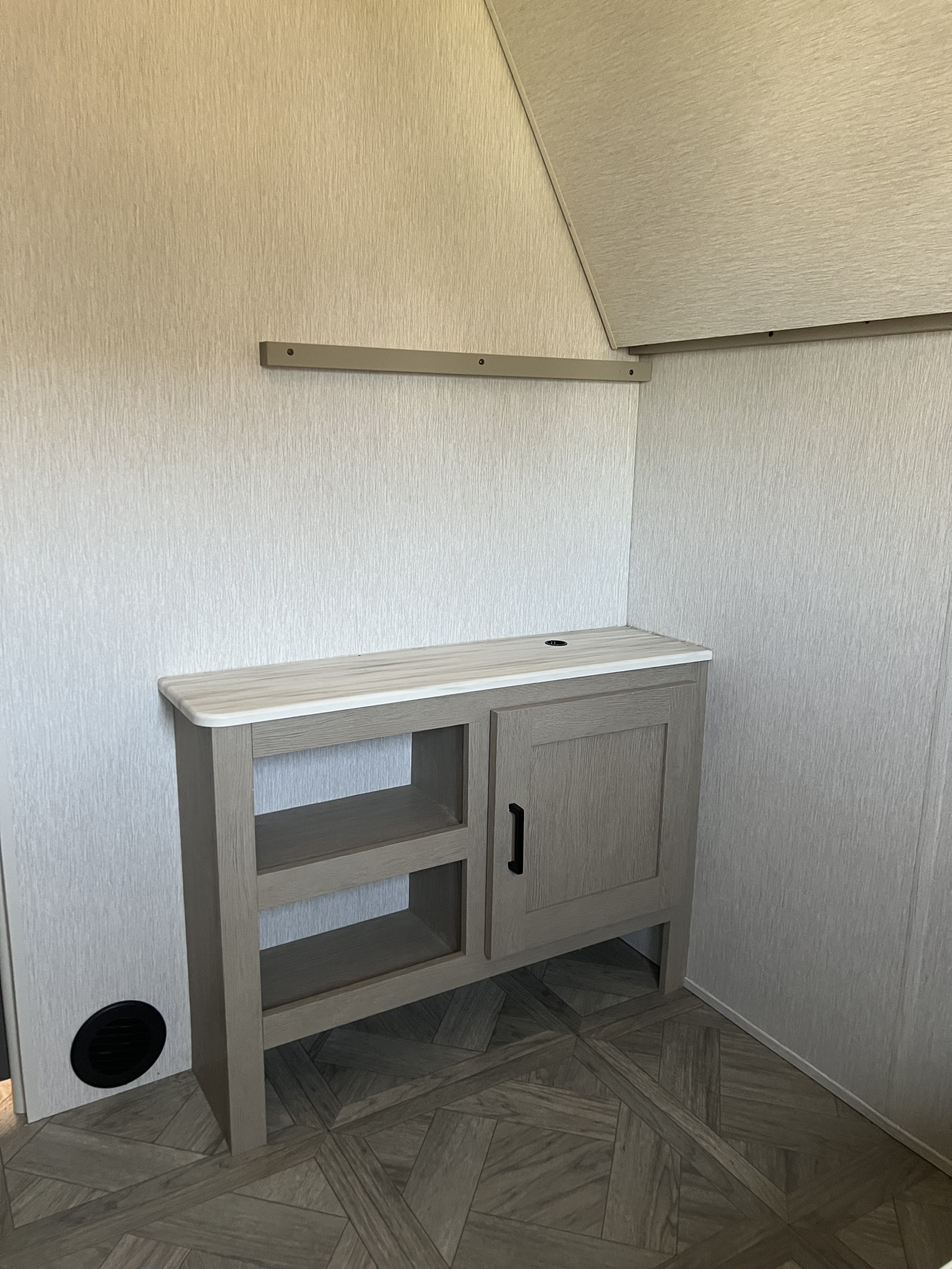 Modern RV rental interior: light wood cabinet with shelves, a counter, and patterned flooring.. Forest River Salem Cruise Lite Platinum 2024