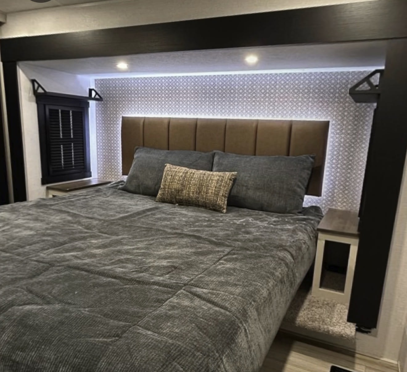 Cozy RV rental bedroom with a plush bed, brown headboard, backlighting, and practical nightstands. A comfortable retreat.. Forest River Salem Hemisphere Elite 2025