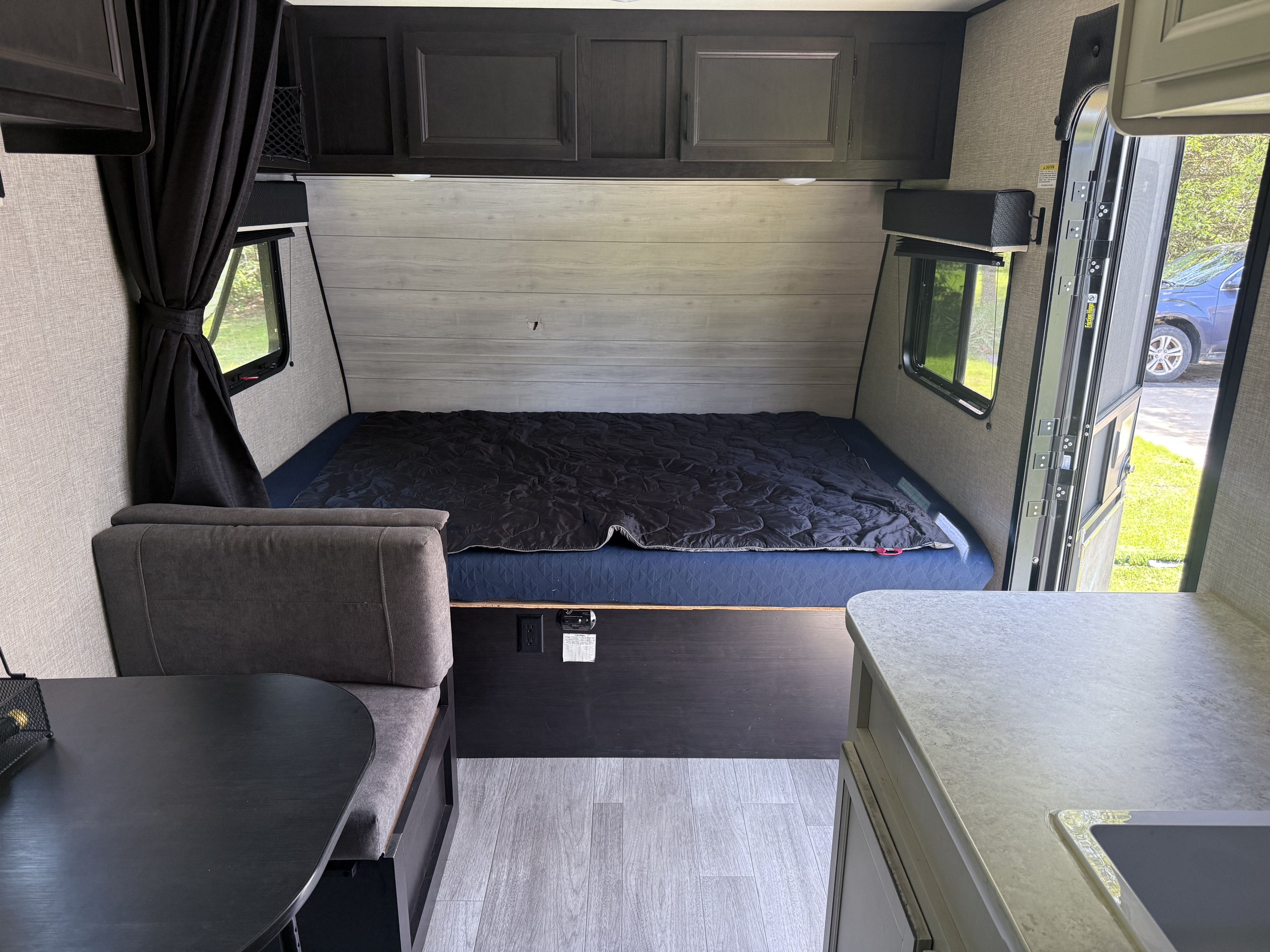 Inside this cozy rv rental: a comfy bed, dinette, and kitchenette with sink, all ready for your next adventure.. Jayco Jay Flight SLX 2022