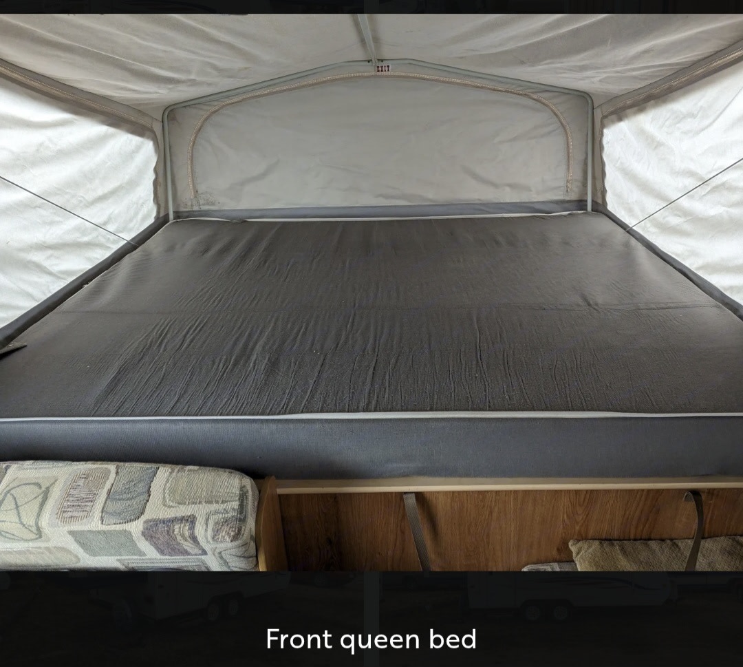 RV rental pop-up camper interior featuring a comfortable front queen bed and canvas tent walls.. Jayco Jay Feather EXP 2008