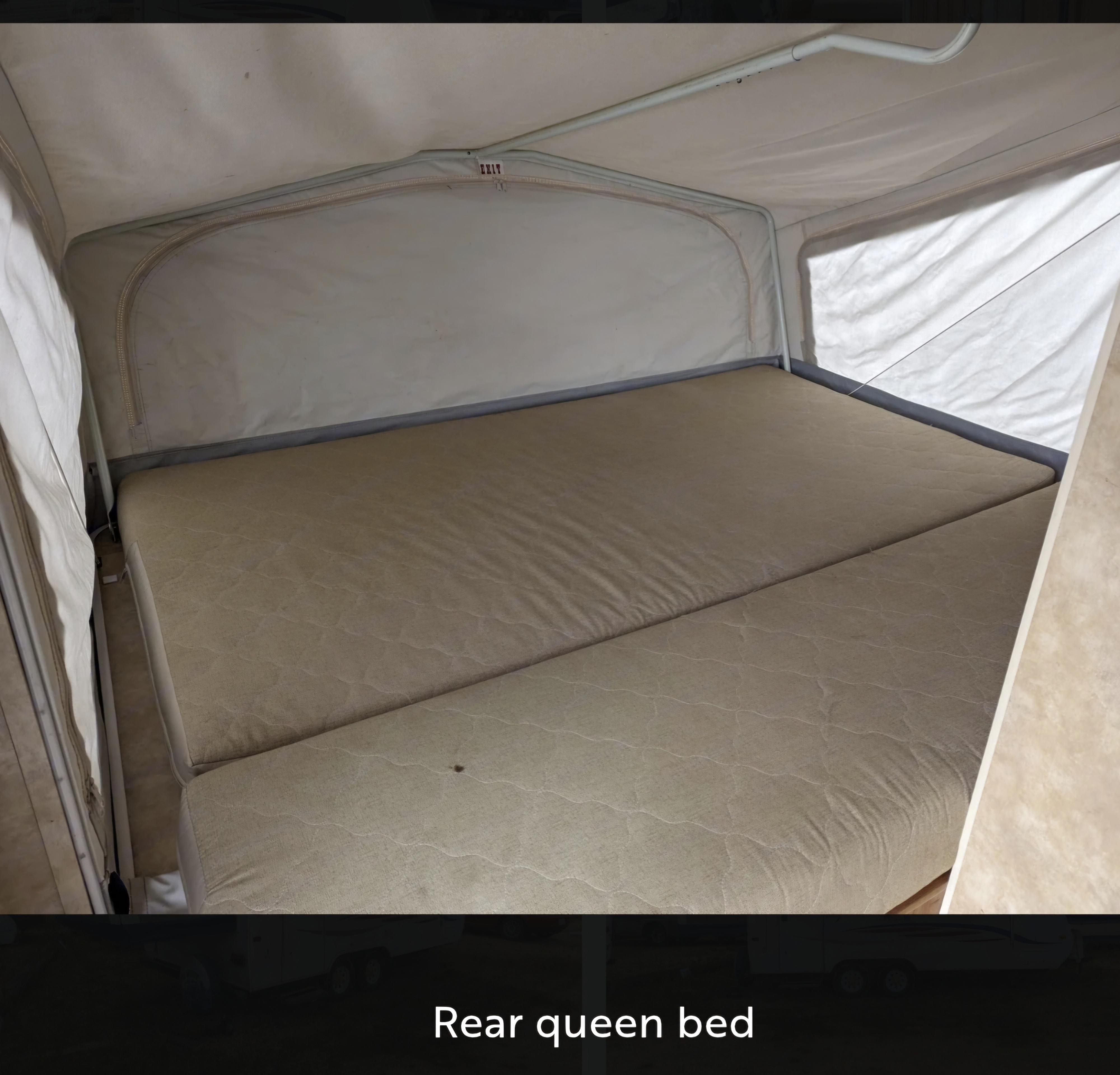 Experience comfort in this RV rental's rear queen bed. The spacious sleeping area features a patterned mattress and fabric walls.. Jayco Jay Feather EXP 2008