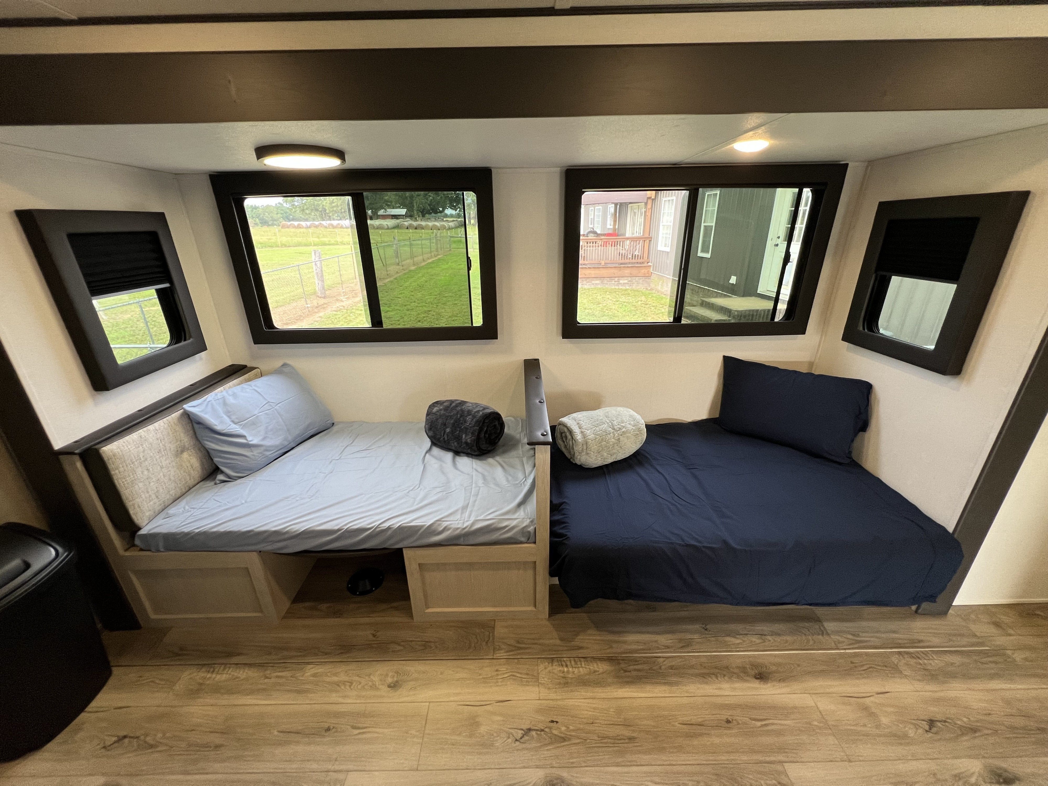 An inviting RV rental sleeping area featuring two twin beds with window views, ready for your next adventure.. Forest River Shasta I-5 2026