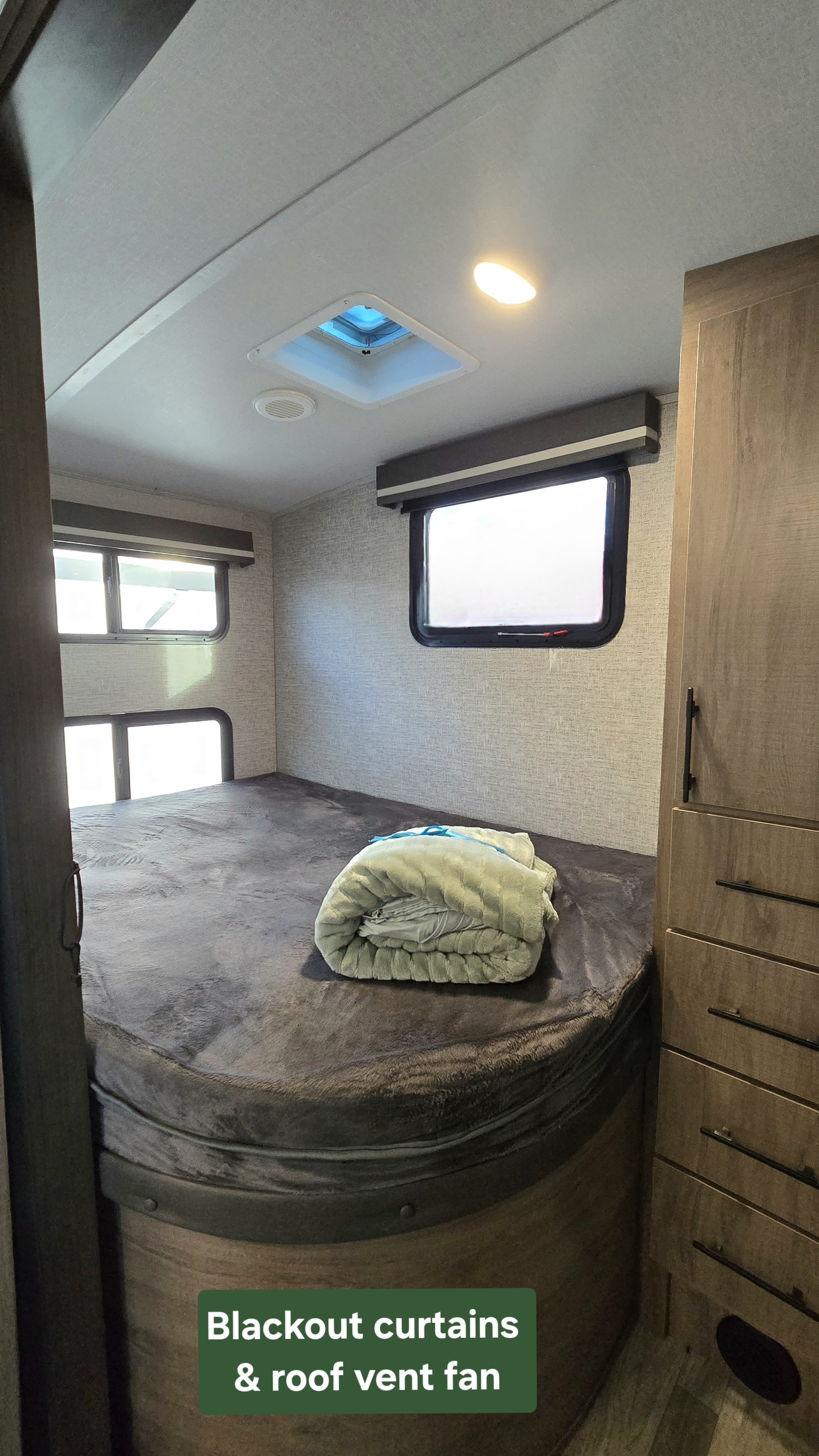 Cozy RV rental bedroom with blackout curtains, a roof vent fan, comfy bed, and ample storage for a comfortable stay.. Grand Design Imagine 2023