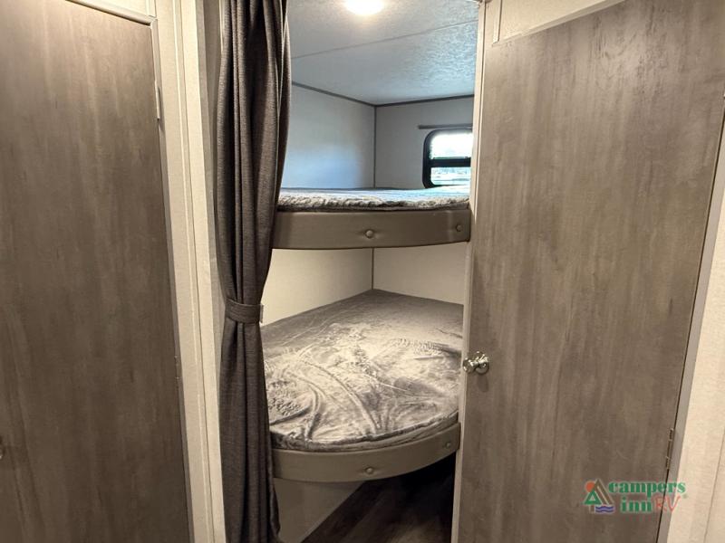 View inside an RV rental: two bunk beds with privacy curtains, perfect for family sleeping arrangements.. Coachmen Catalina 2025