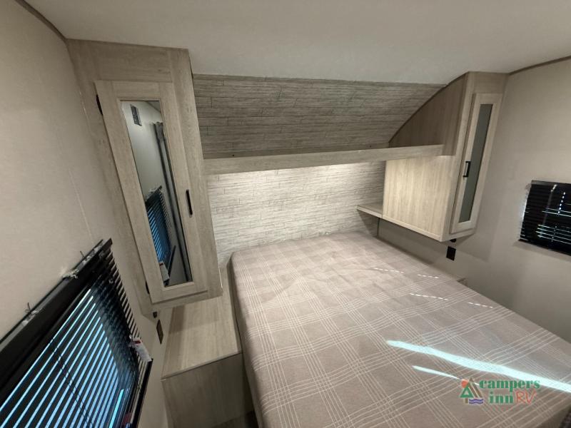 Comfortable RV rental bedroom featuring a cozy bed, modern overhead storage, and windows with blinds for your next adventure.. Coachmen Catalina 2025