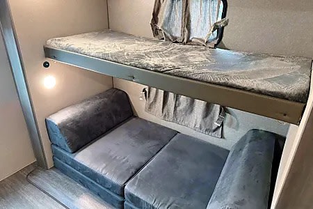 Cozy RV rental bunk beds feature a comfy top bunk and a versatile lower sofa for sleeping or lounging in your camper.. Forest River Aurora Aurora 2023