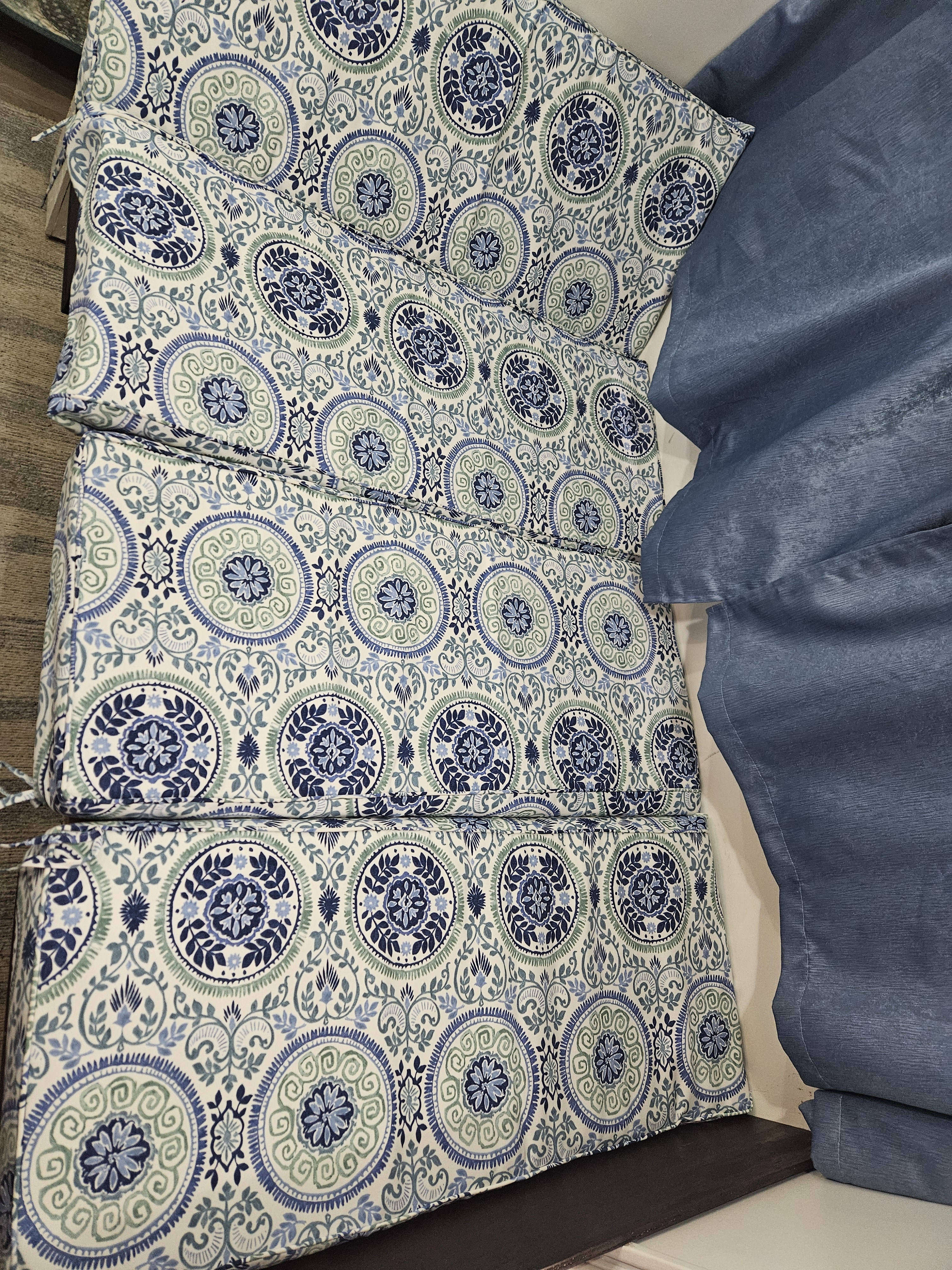 Several blue & white medallion-patterned cushions with solid blue fabric, creating a welcoming look for an RV rental.. Thor Motor Coach Tahoe Pak Rat 1998