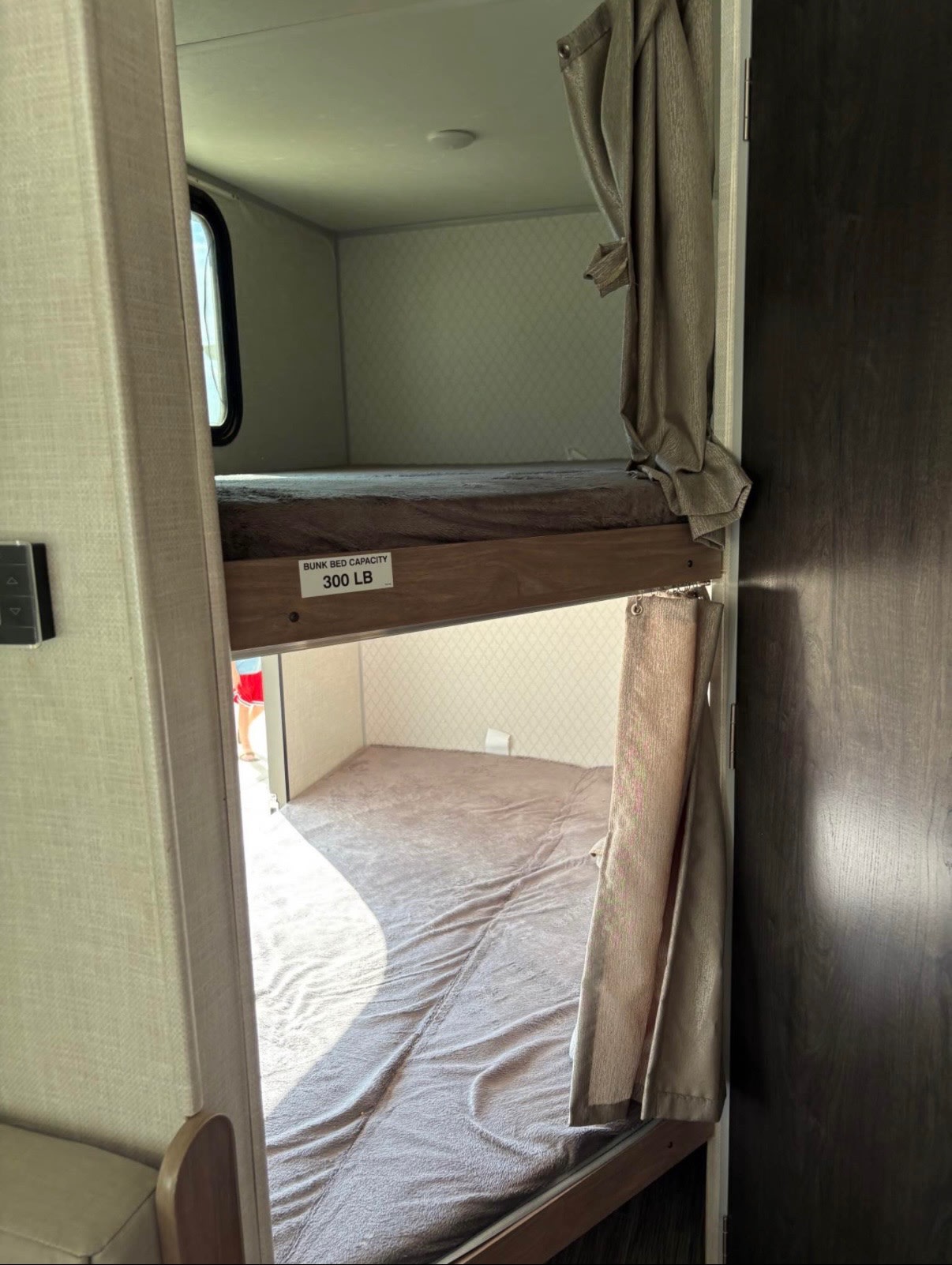RV rental bunk beds with 300 lb capacity visible, offering a cozy sleeping area in the camper.. No Boundaries 19 2020