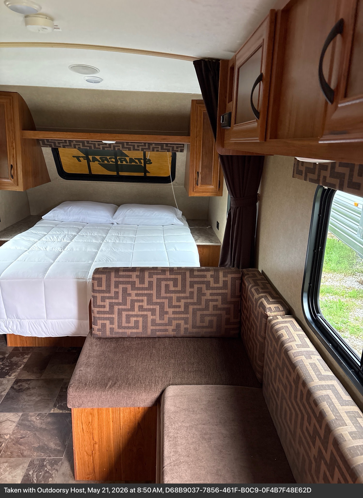 Cozy rv rental interior: comfortable bed, dinette, and wood cabinets create a functional living space.. Starcraft AR-One 2017