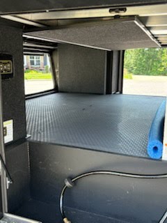 This RV rental's versatile rear cargo bay features a raised platform with durable mat, overhead carpeted bunk, and utility hose.. Brinkley RV Model G Toy Hauler 2025