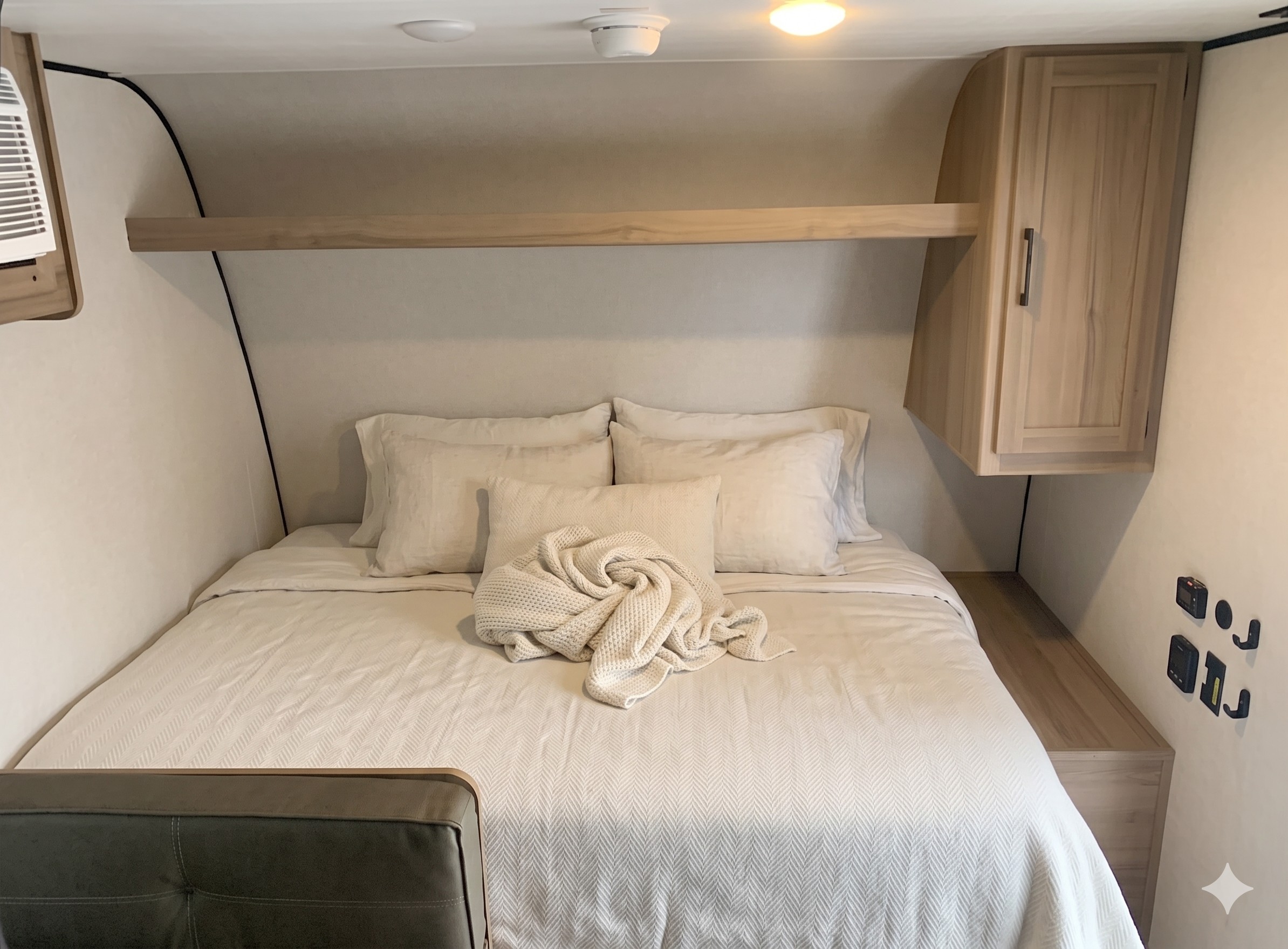 RV rental bedroom: a cozy retreat with a queen bed, crisp white linens, and ample storage for a comfortable journey.. Keystone RV Coleman Legacy 2026