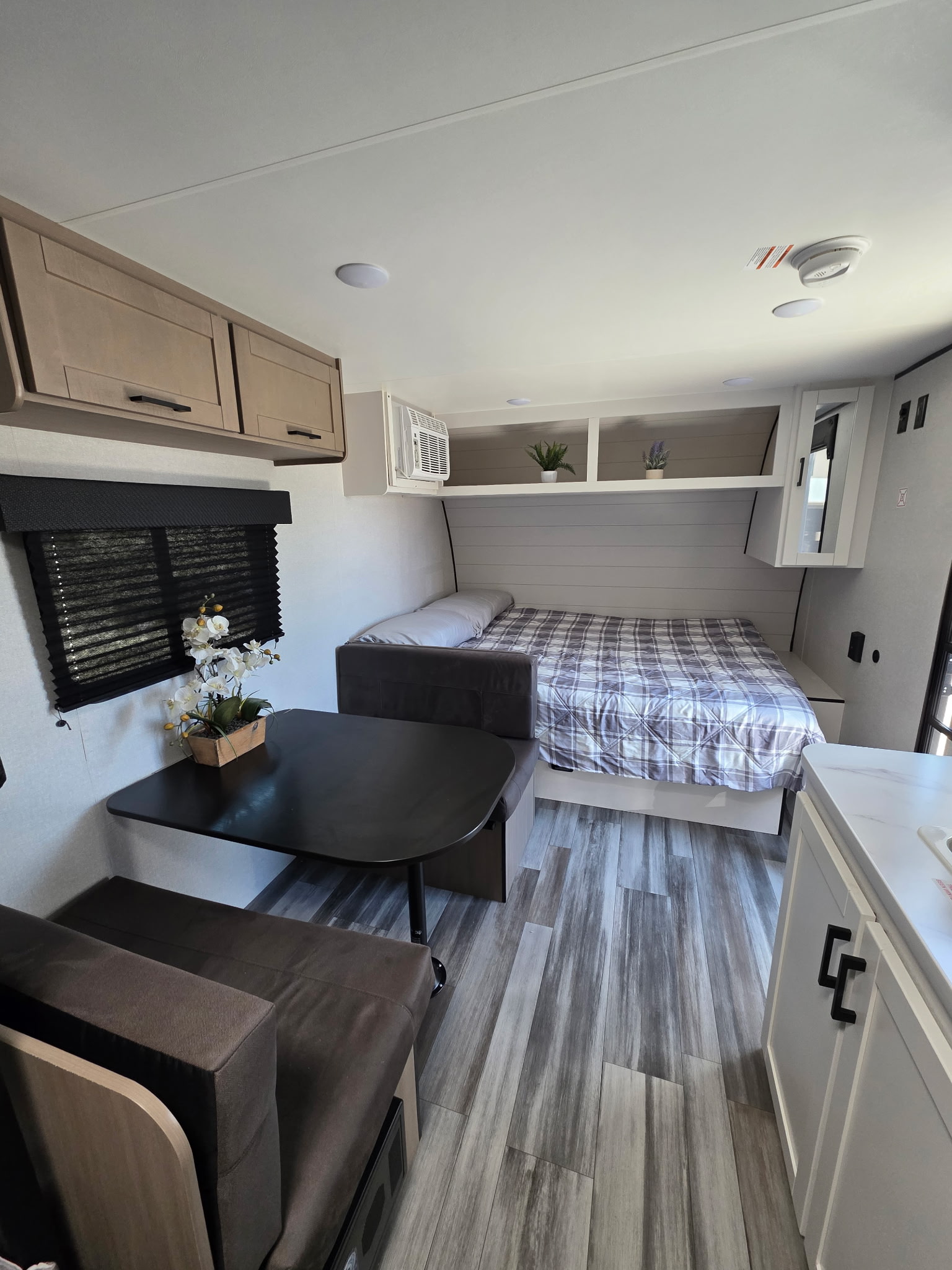 Inside an RV rental: a compact living space with bed, dinette, kitchen counter, and ample storage for comfortable travel.. Jayco Jayco 2026