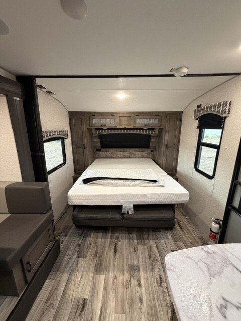 Cozy RV rental bedroom with a comfortable bed and ample storage, perfect for your next adventure.. Venture RV Sonic 2022