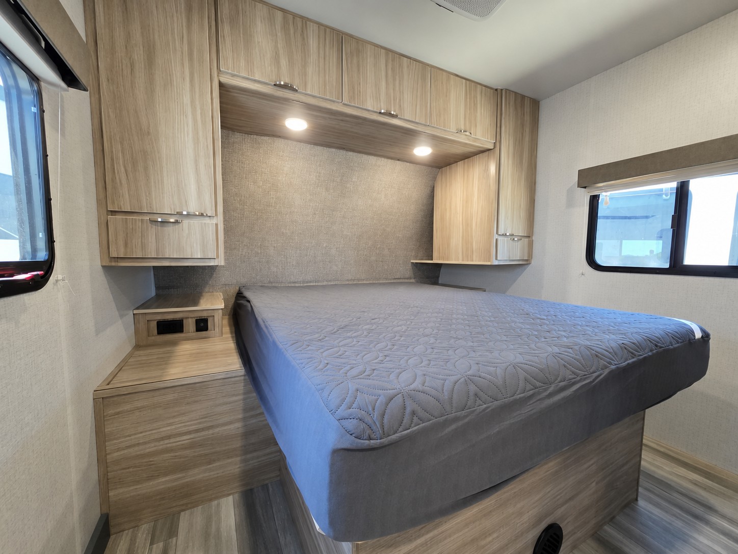 RV rental bedroom: Modern space with light wood cabinetry, comfy bed & window. Perfect for your next travel adventure.. Minnie Minnie Trailer 2022