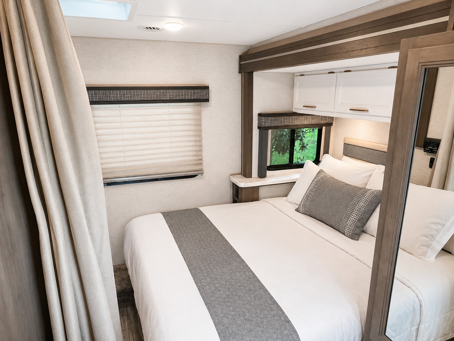 Experience comfort in this cozy RV rental bedroom. Features a modern bed, window, and overhead storage.. Thor Chateau 2024