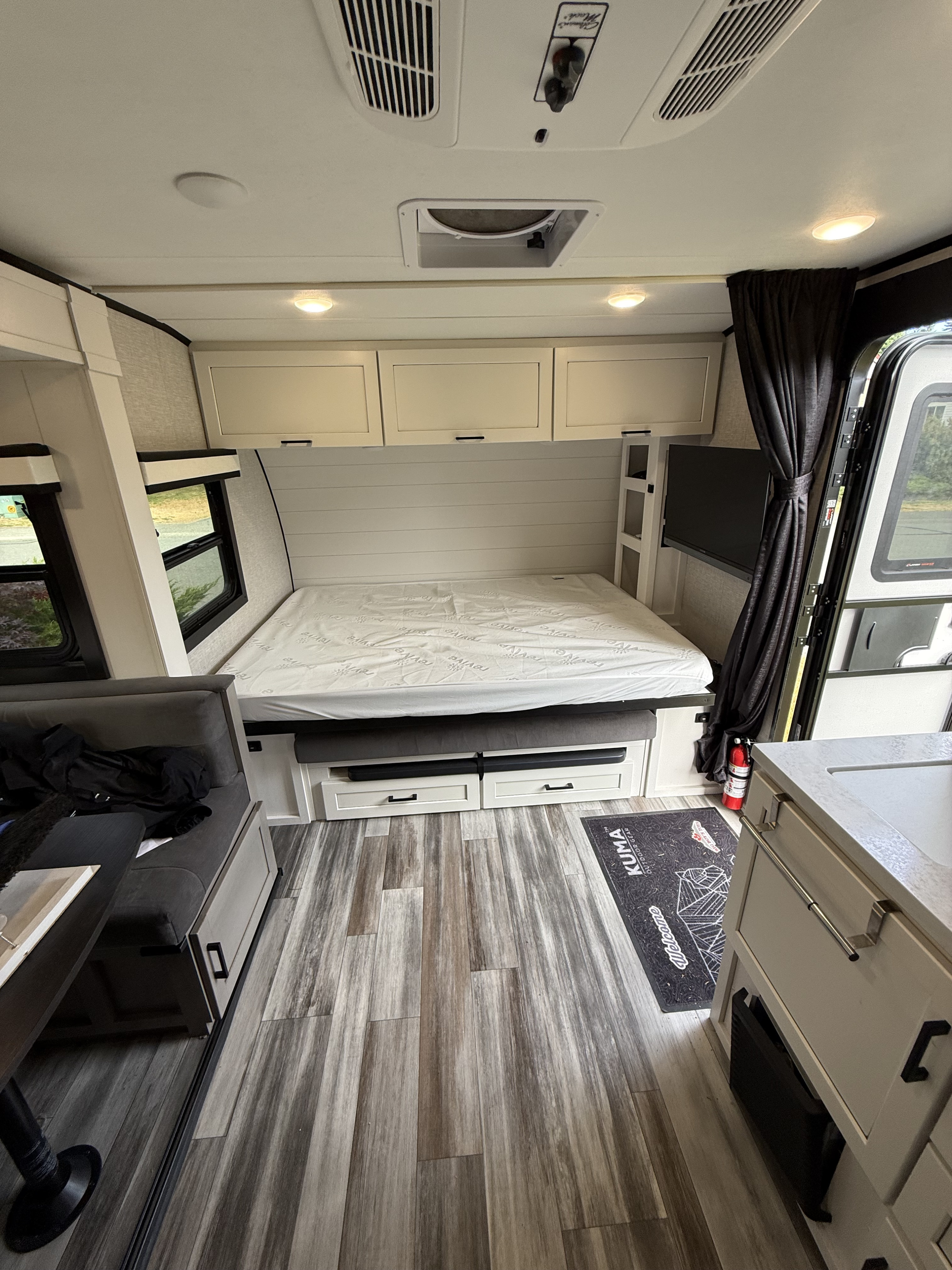 This clean, modern rv rental interior features a comfortable bed, dinette, kitchen area, and essential amenities for your trip.. Jayco Jay Feather Micro 2025