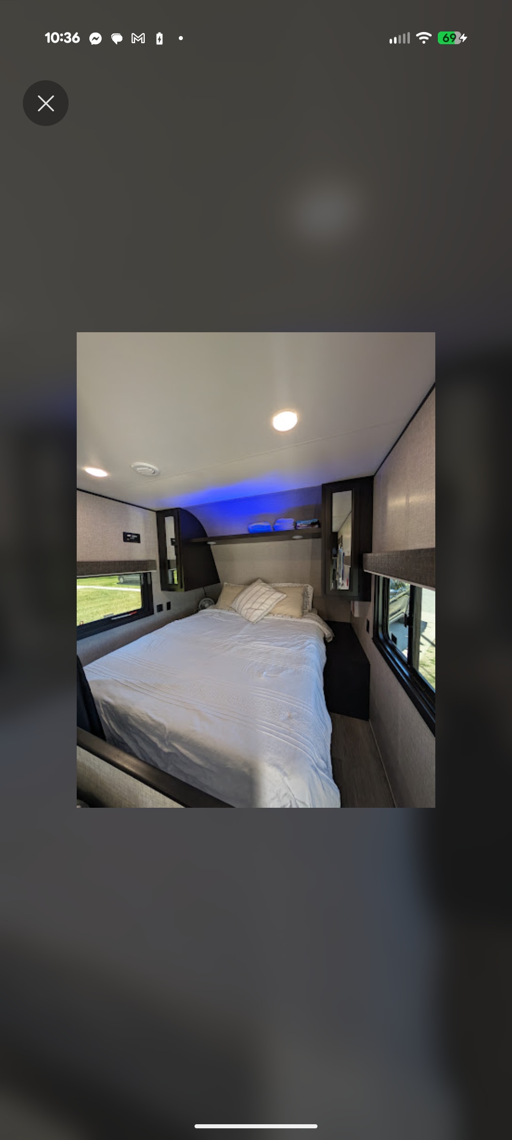 Comfortable RV rental bedroom with a neatly made bed, windows, and modern lighting, perfect for your next trip.. Jayco Jay Flight SLX 2022
