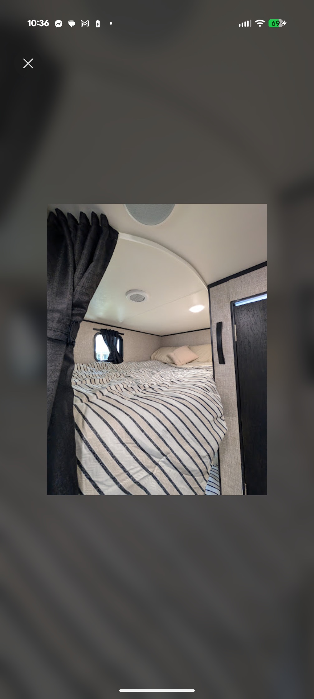 Cozy RV rental sleeping space with striped bedding, soft pillows, a window, and privacy curtains.. Jayco Jay Flight SLX 2022
