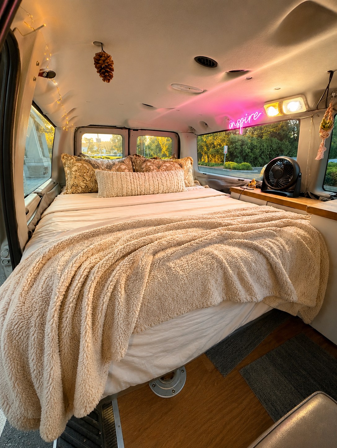 Explore comfort in this RV rental: a cozy bed, "inspire" neon, and ambient lighting in a van conversion.. Ford Econoline 2009
