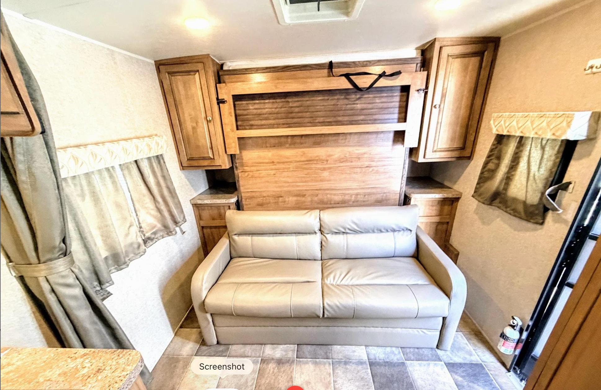 Explore this RV rental's versatile living space: a comfortable sofa, convertible murphy bed, and ample storage.. Forest River Flagstaff Micro Lite XLT 2017