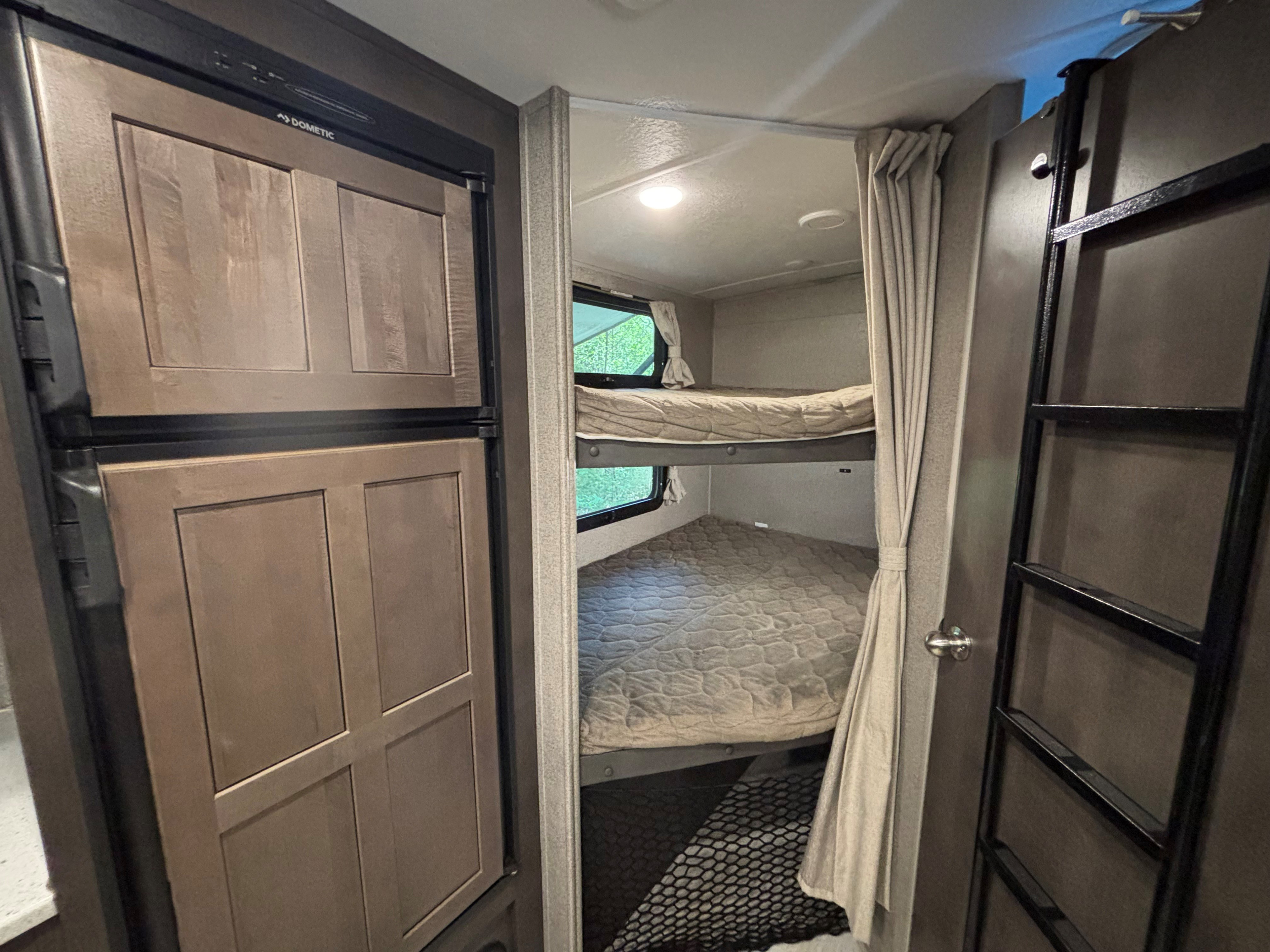 Cozy bunk beds and a Dometic fridge in this rv rental offer compact comfort for travel adventures.. Forest River Flagstaff Micro Lite 2019
