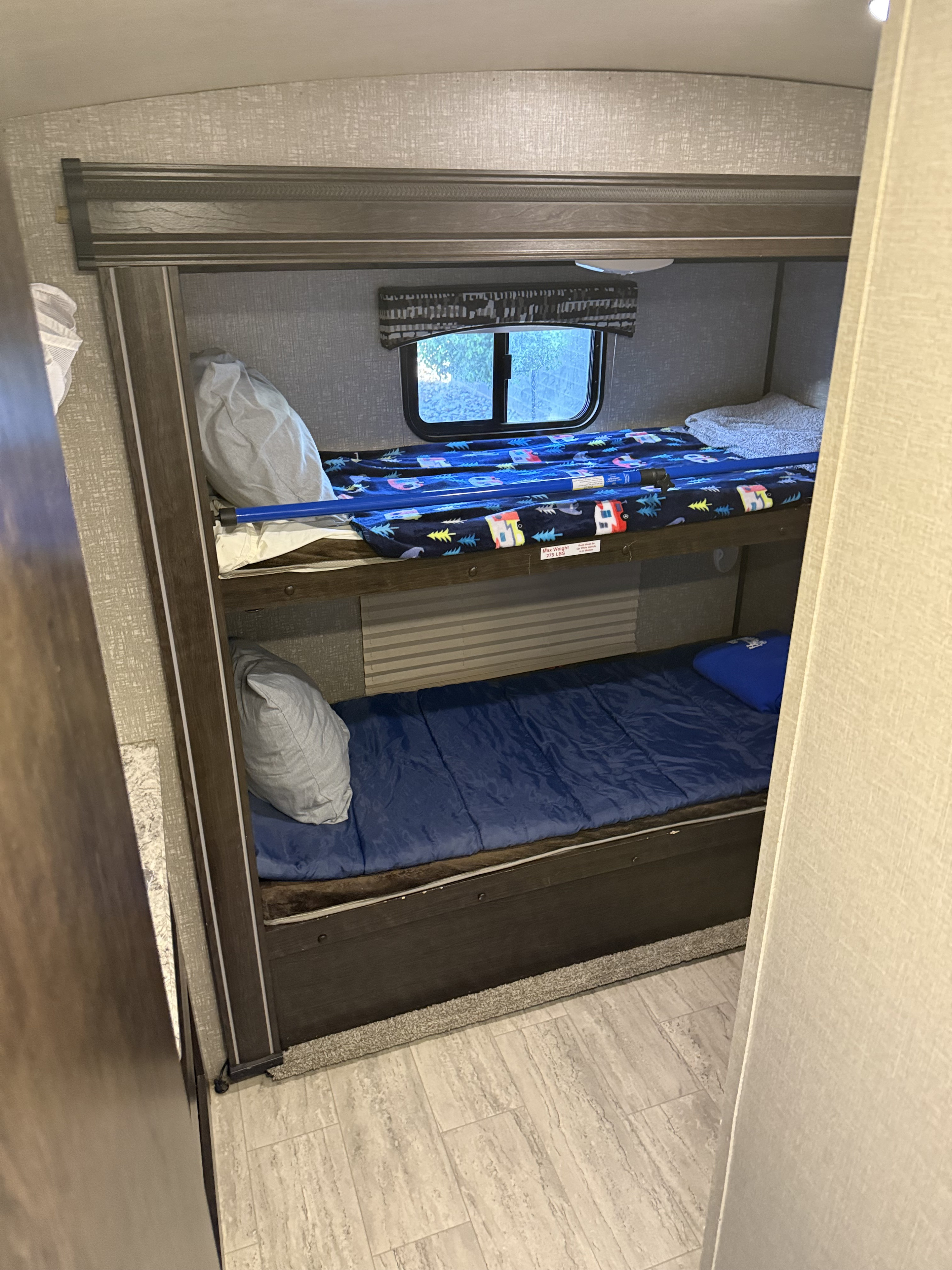 RV rental interior: cozy bunk beds with a camper-themed blanket on the top bunk, ready for adventures.. Cruiser RV Shadow Cruiser 2018