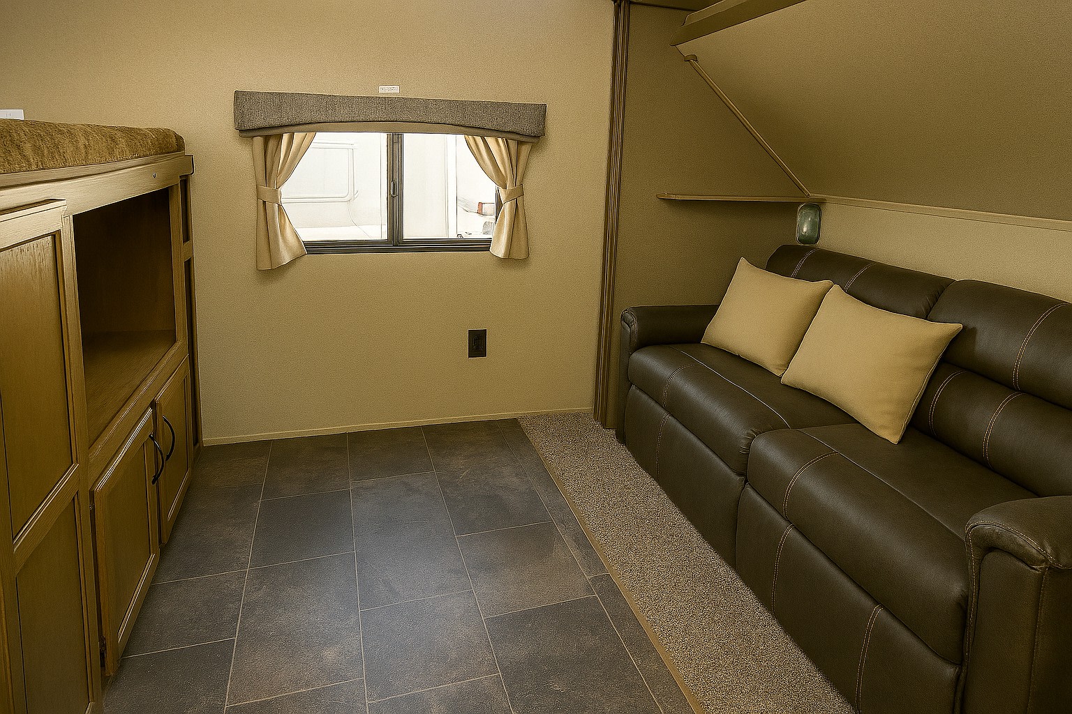 RV rental interior: bunk bed with storage, window, and brown sofa with pillows. Tiled floor transitions to carpet for comfort.. Crossroads RV Rezerve 2016