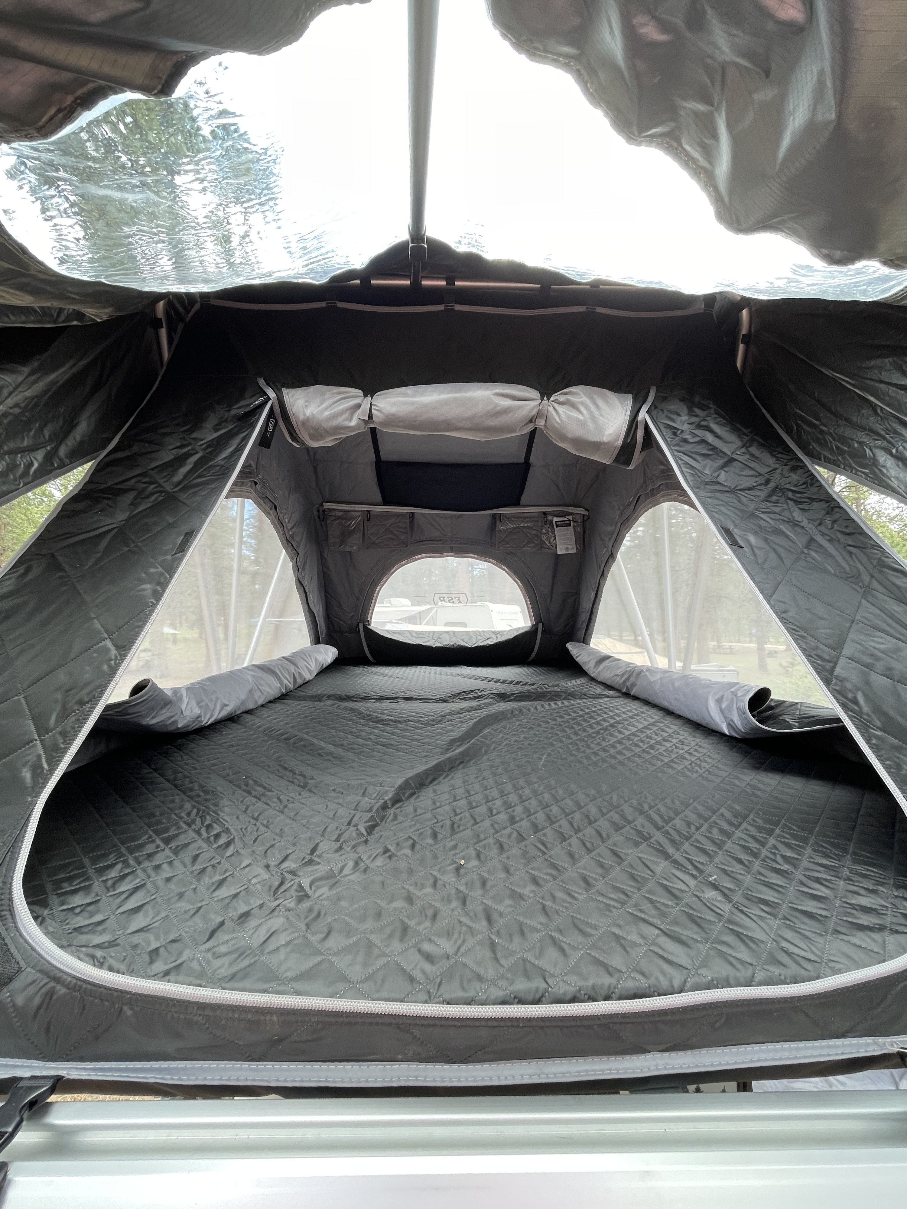 Interior of a comfortable rooftop tent, perfect for an RV rental adventure. Features quilted mattress, mesh windows & storage.. Boreas MXT 2020