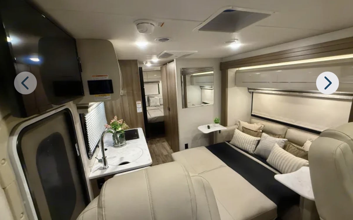 Spacious and modern RV rental interior featuring a living area, kitchen, and bedroom. Perfect for your next adventure.. Thor Motor Coach Vegas 2026