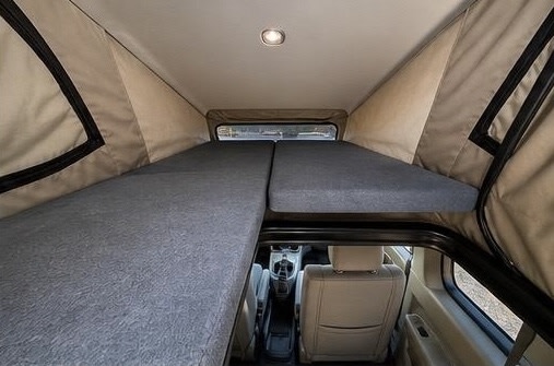 Pop-top RV rental interior showing stacked sleeping platforms; a cozy, efficient setup for adventure.. Honda Element 2011